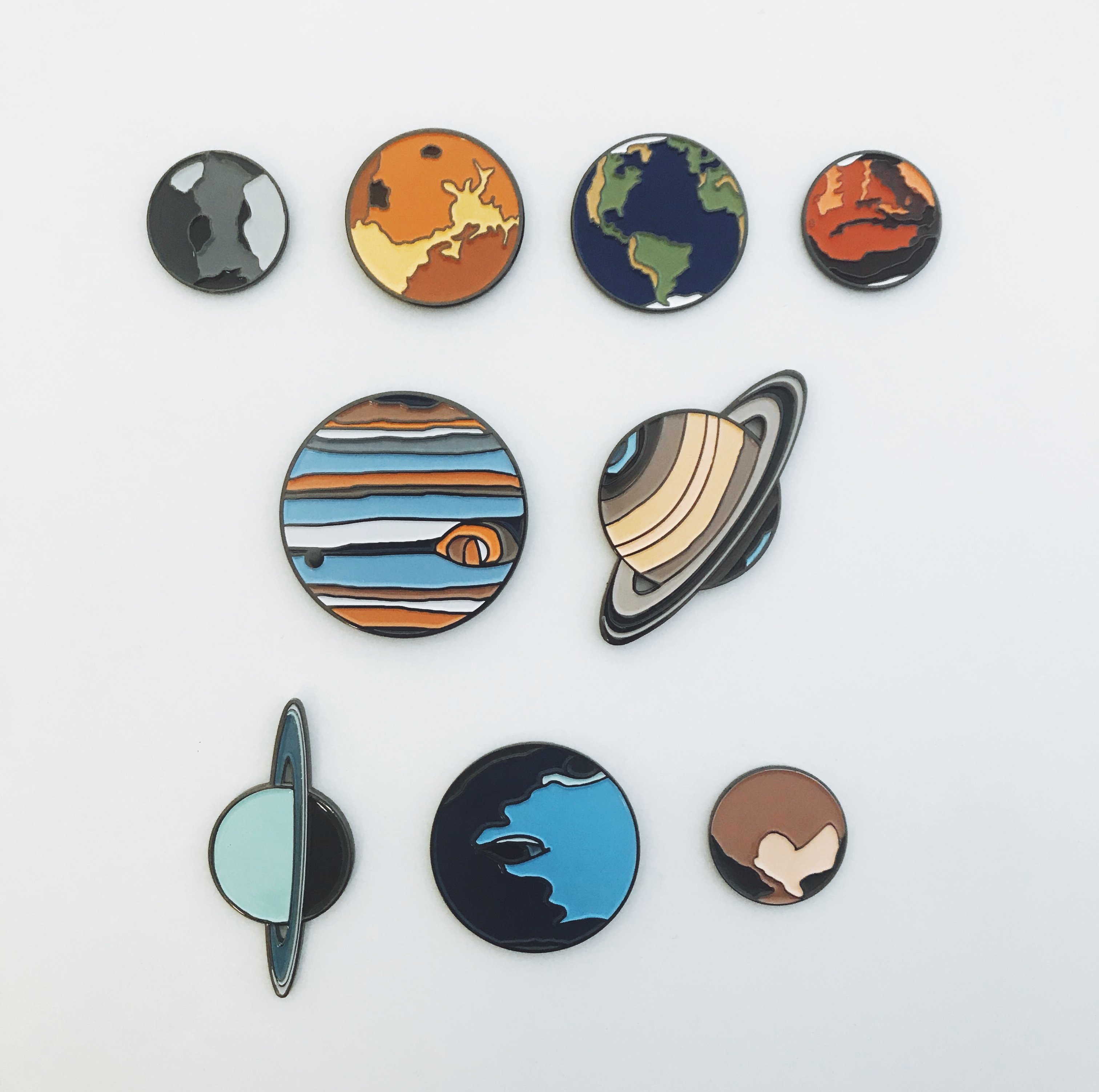 A colorful Earth Enamel Pin featuring a vibrant blue planet design, perfect for jackets and backpacks.