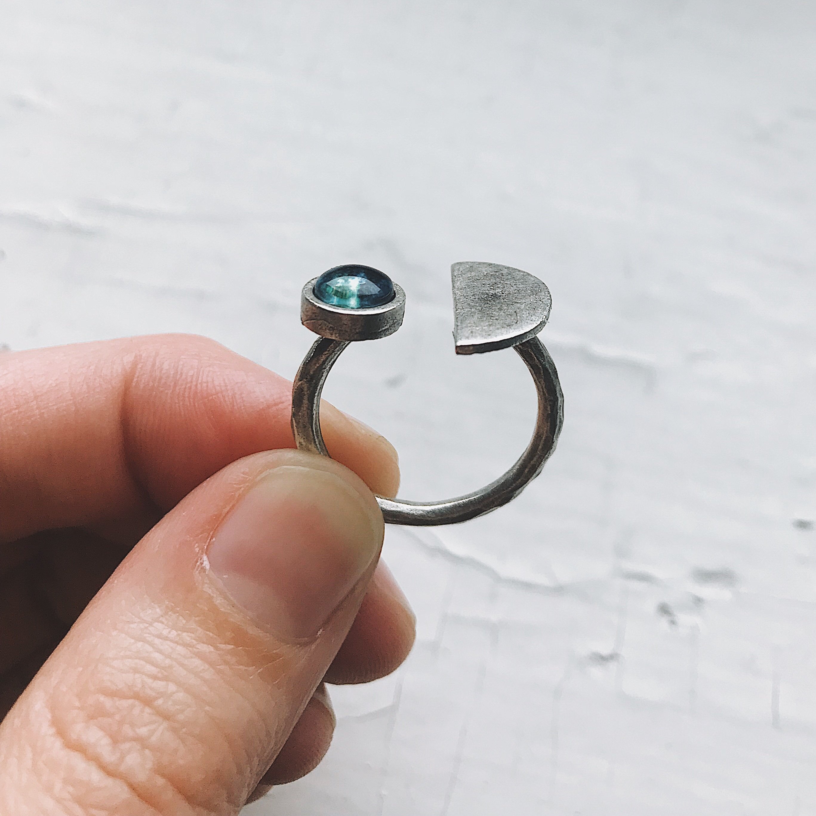 Earth Rise Ring featuring a glass image of Earth from the Moon, handcrafted in rhodium plated brass, available in silver and gold tones.