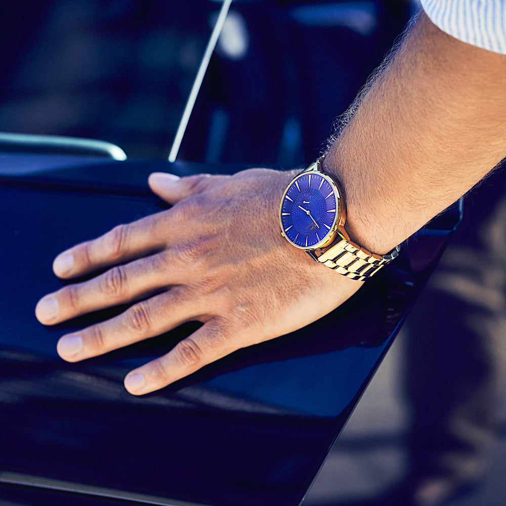 Eclipse watch featuring rose gold gloss finish and cobalt blue accents, showcasing a domed sapphire crystal and intricate guilloche pattern dial.