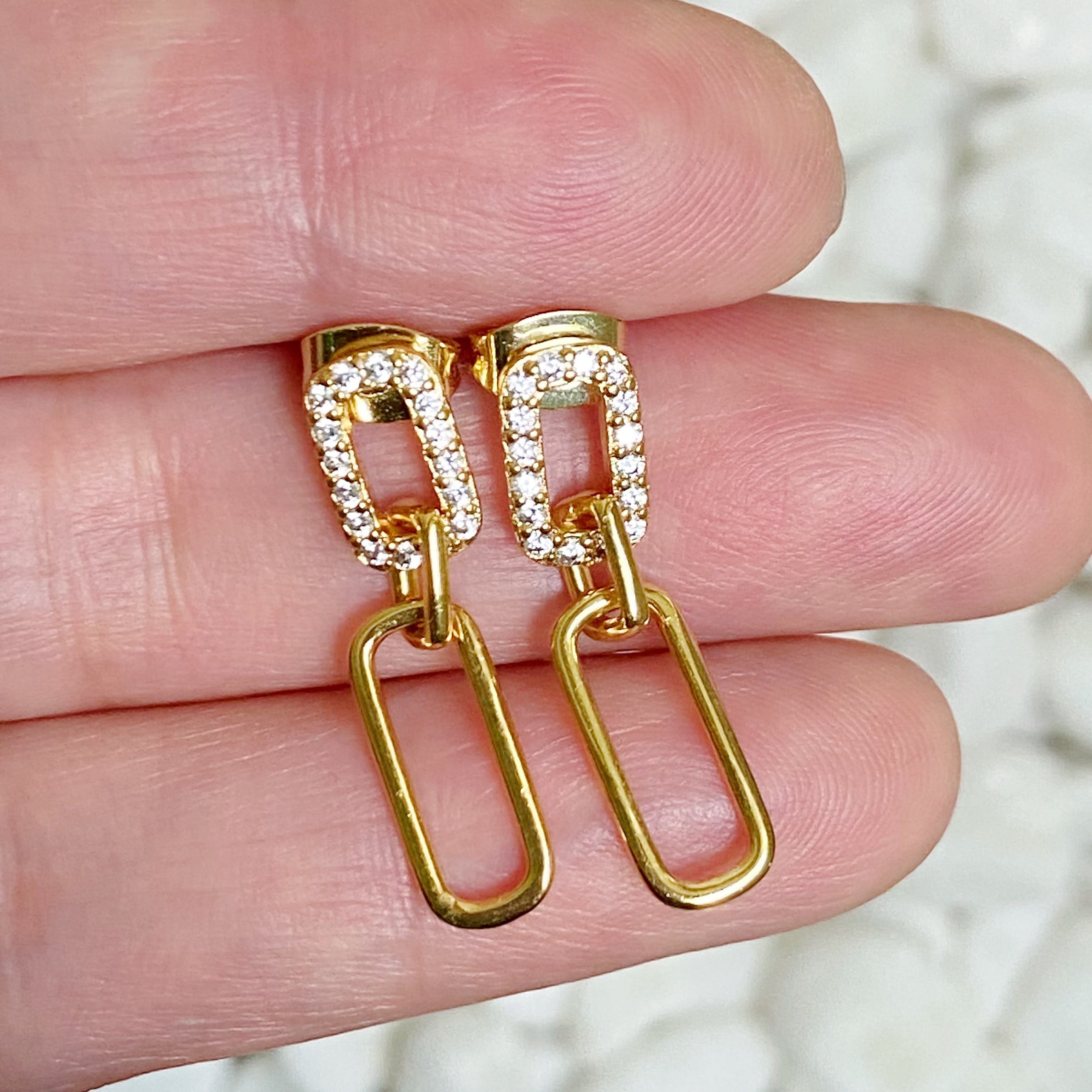 Elegant Edge Dangle Earrings featuring sparkling cubic zirconia stones and gold plated brass, perfect for any occasion.