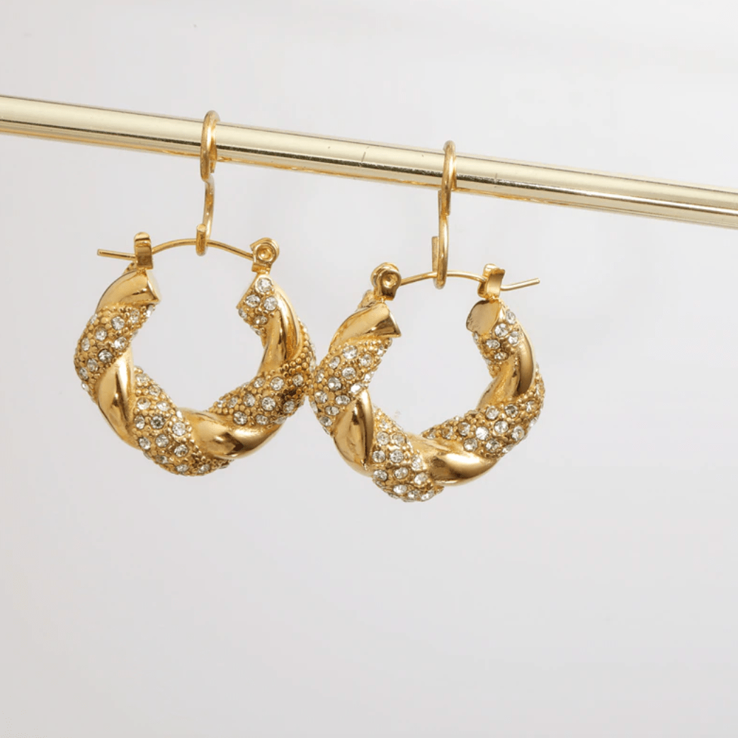 Elegant Egypt twist hoop earrings made of stainless steel with 18K gold PVD plating and zircon crystal pavé, showcasing a unique twist design.