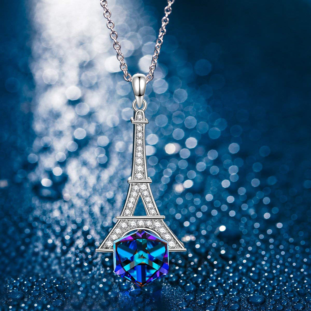 Eiffel Tower Blue Cubed Pendant Necklace featuring a blue princess cut crystal on a 14K gold plated link chain.