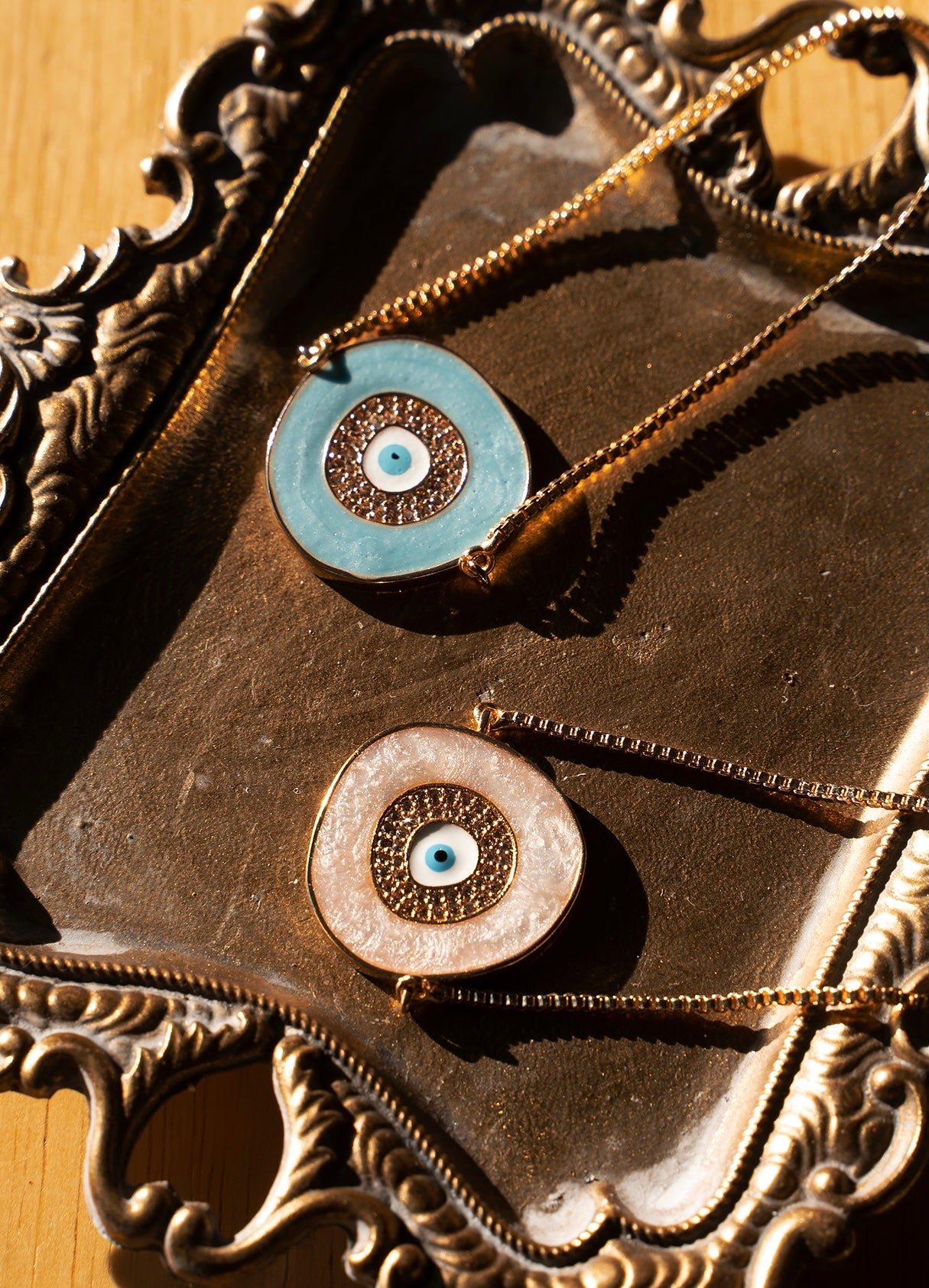 A beautiful ELA Bracelet featuring a baby blue enamel evil eye charm, adjustable bolo design, and yellow gold plating.