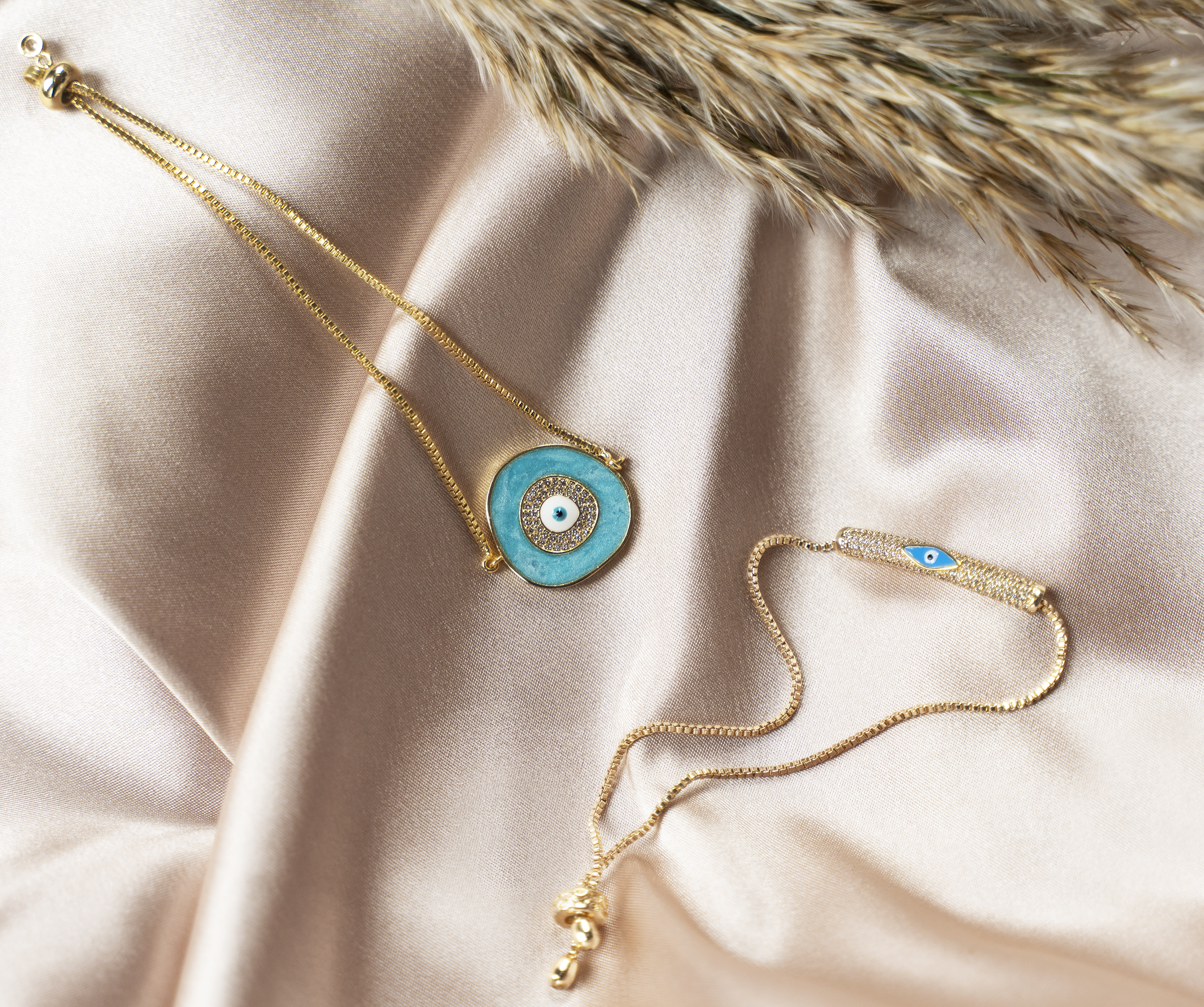 A beautiful ELA Bracelet featuring a baby blue enamel evil eye charm, adjustable bolo design, and yellow gold plating.