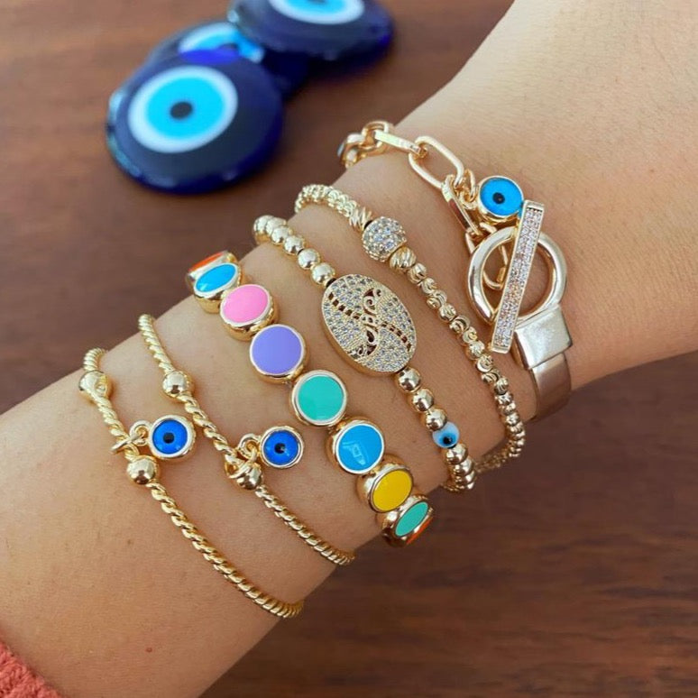 Elegant Evil Eye Bracelet featuring a gold bangle design, handmade with tarnish-resistant stainless steel, adjustable for all wrist sizes.