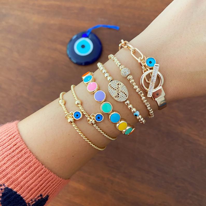 Elegant Evil Eye Bracelet featuring a gold bangle design, handmade with tarnish-resistant stainless steel, adjustable for all wrist sizes.