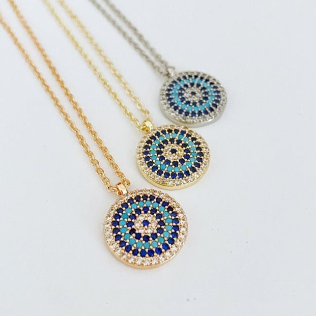 Elegant Evil Eye Necklace featuring a zircon charm on a gold, silver, or rose gold chain, symbolizing protection and style.