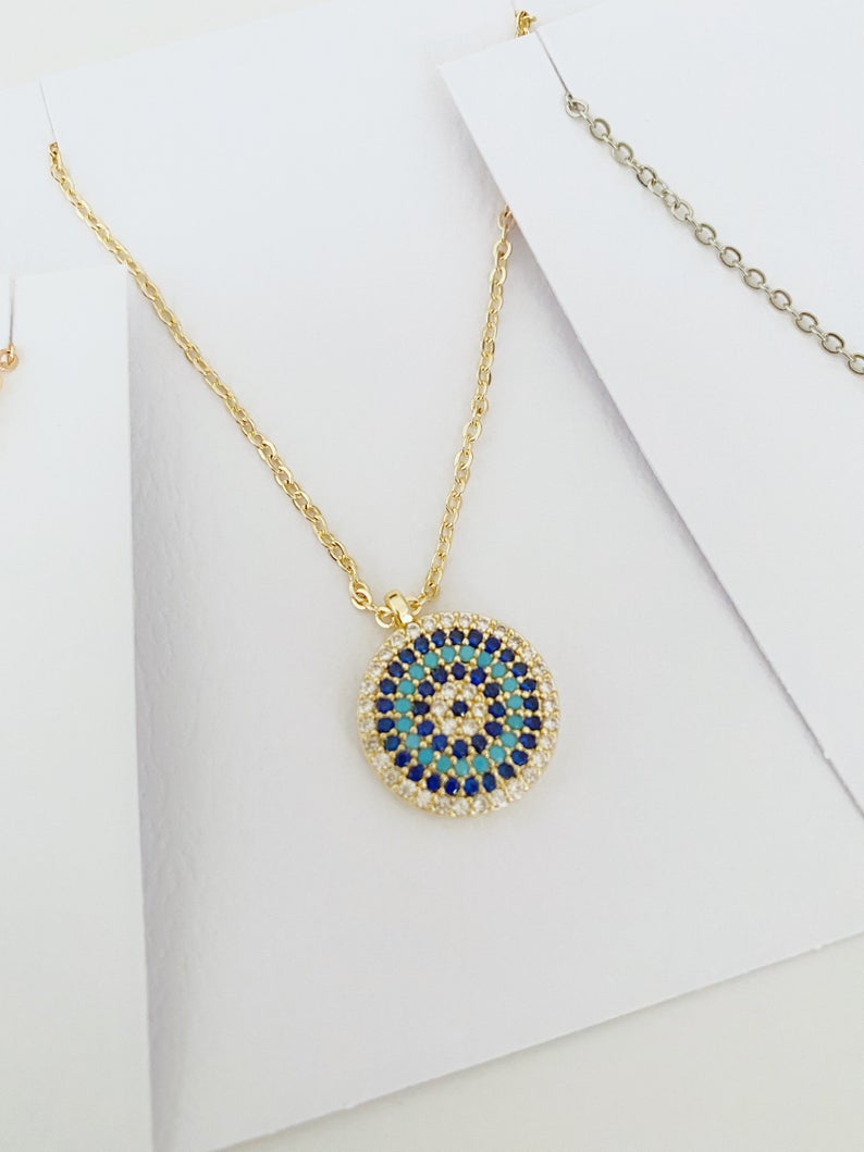 Elegant Evil Eye Necklace featuring a zircon charm on a gold, silver, or rose gold chain, symbolizing protection and style.