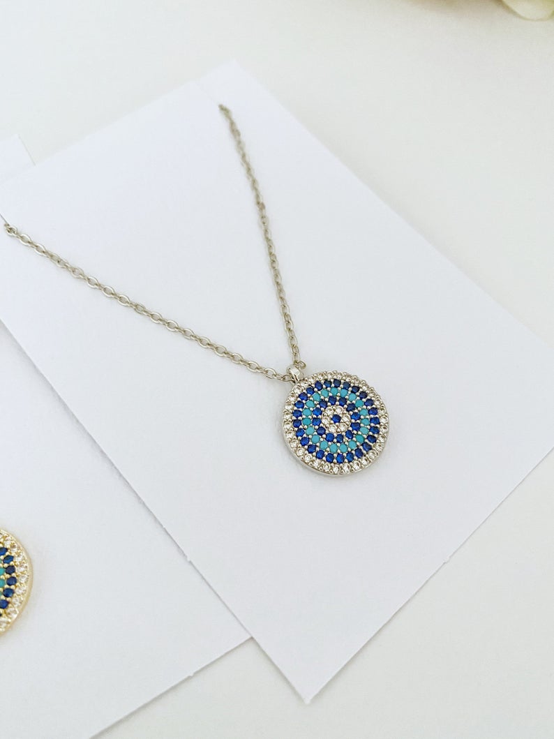 Elegant Evil Eye Necklace featuring a zircon charm on a gold, silver, or rose gold chain, symbolizing protection and style.