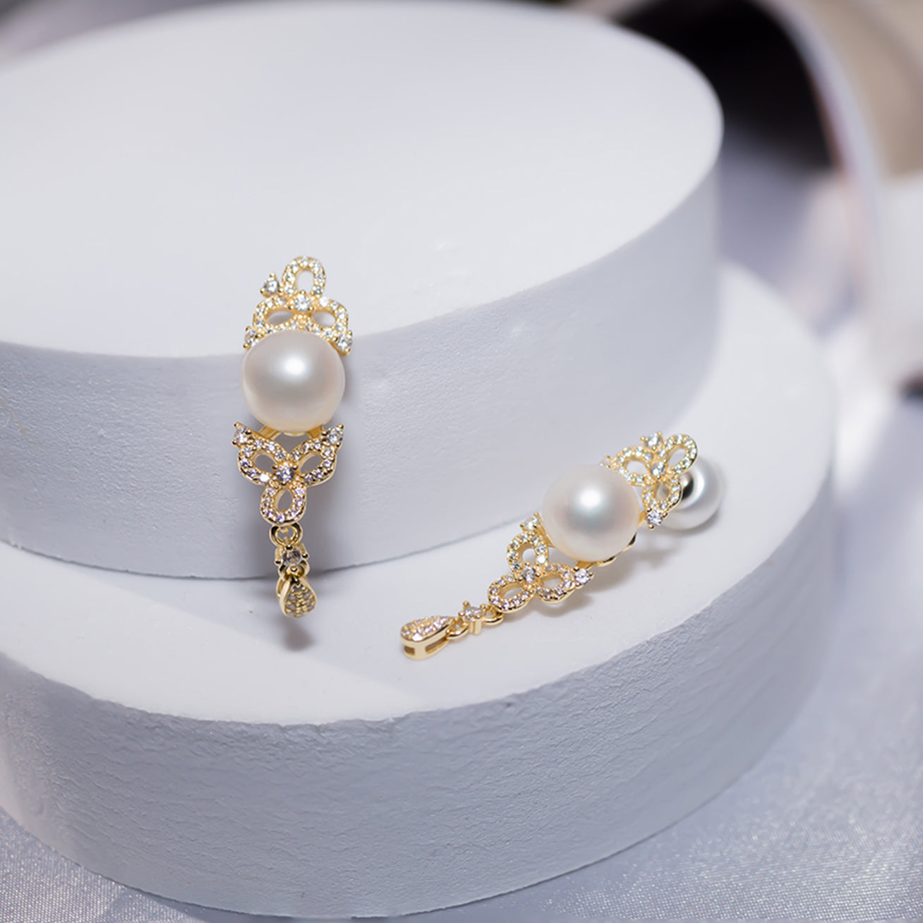 Elegant Freshwater Pearl Earrings featuring a round white pearl, sterling silver, and cubic zirconia accents, inspired by traditional Chinese knots.