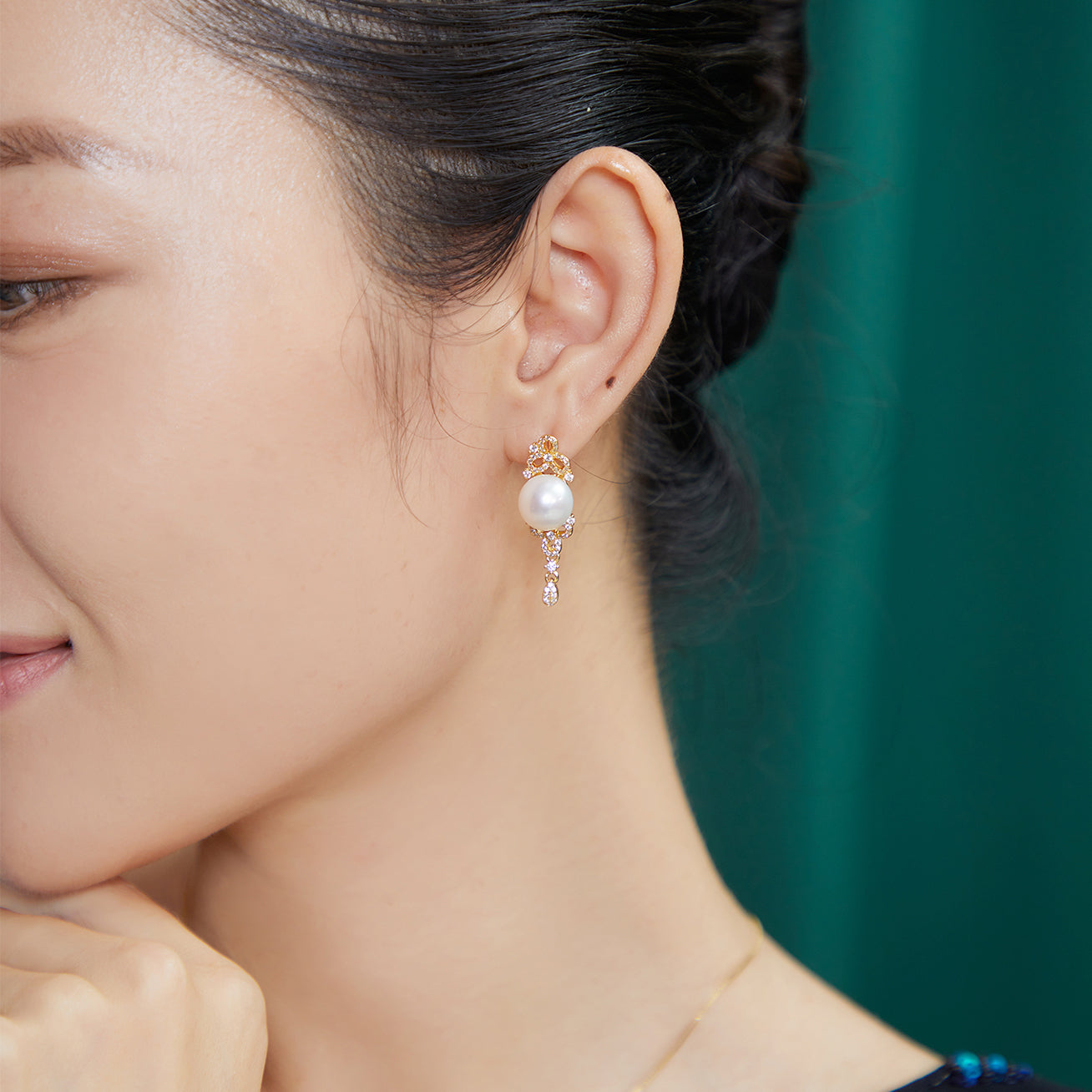 Elegant Freshwater Pearl Earrings featuring a round white pearl, sterling silver, and cubic zirconia accents, inspired by traditional Chinese knots.