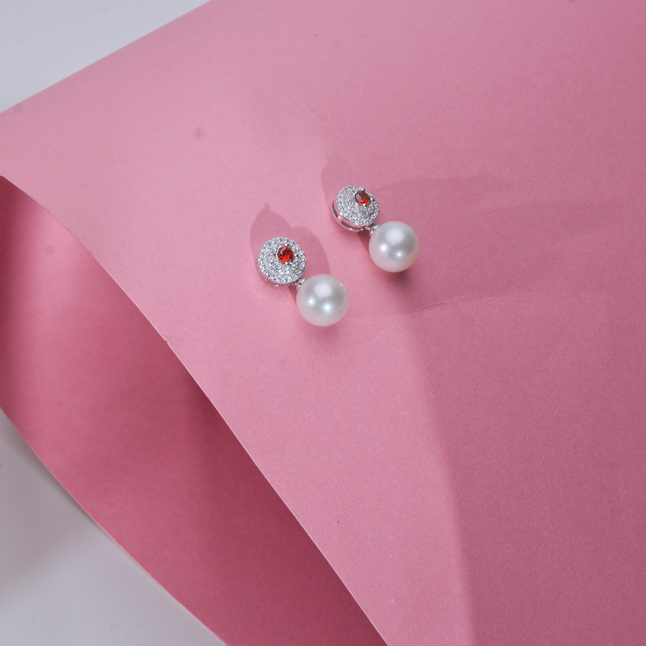 Elegant Freshwater Pearl Earrings featuring ruby red cubic zirconia, crafted in sterling silver with gold plating.