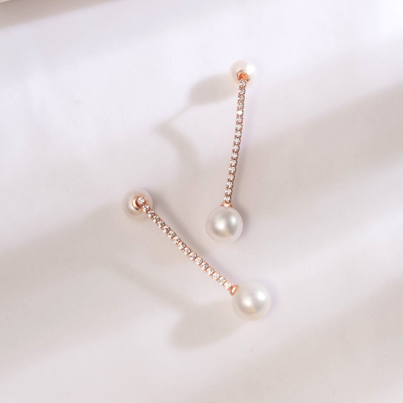 Elegant Freshwater Pearl Earrings featuring 8-9mm round white pearls, sterling silver, and rose gold plating.