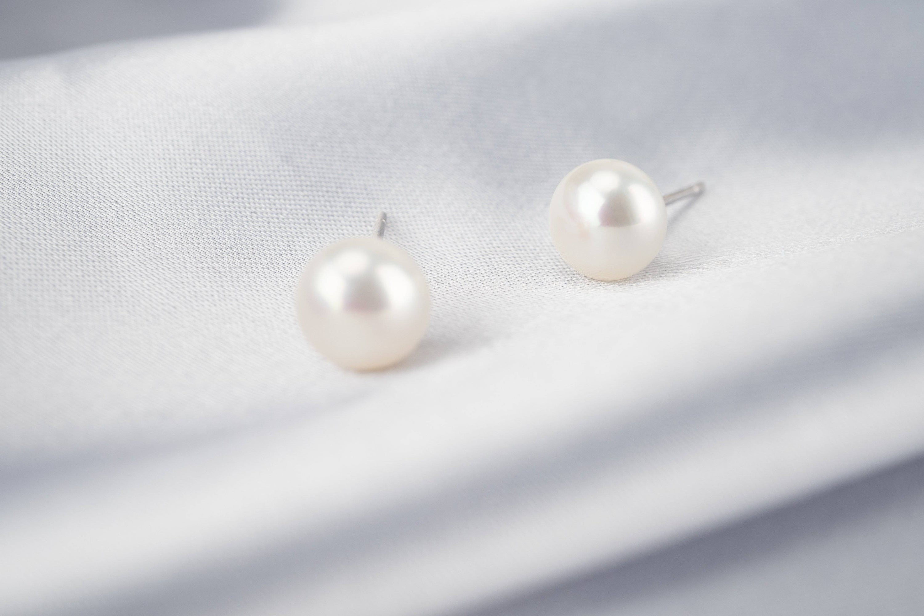 Elegant Freshwater Pearl Earrings WE00058 featuring white semi-round pearls and sterling silver with gold plating.