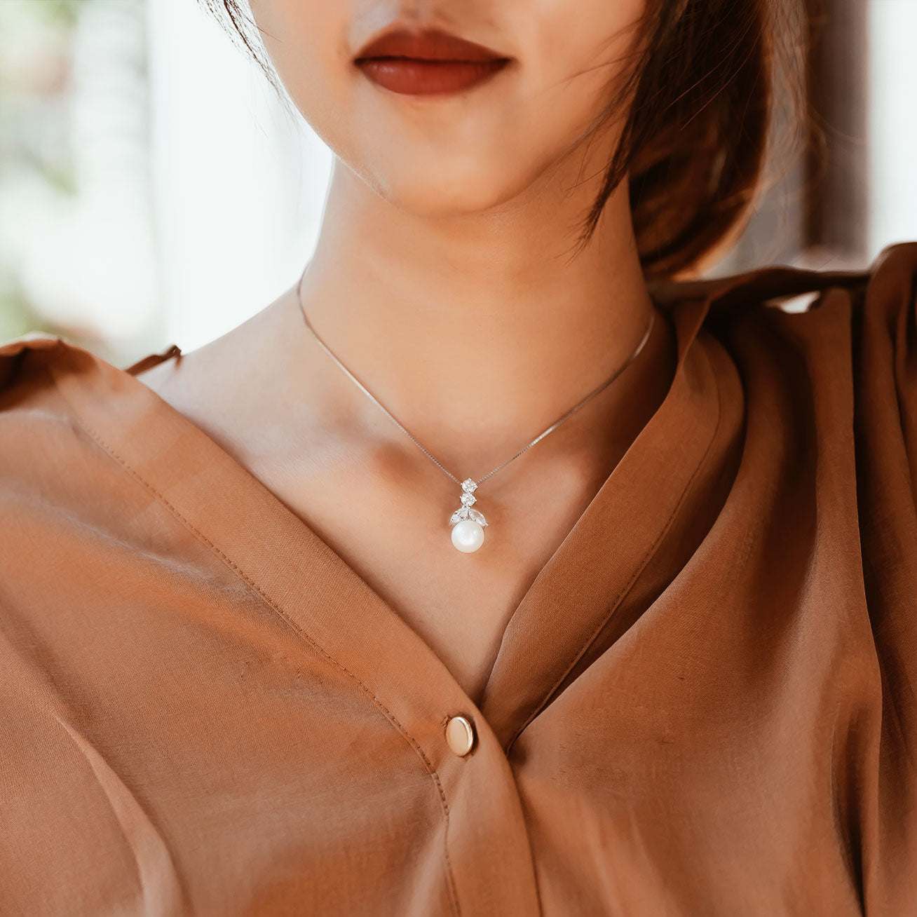 Elegant Freshwater Pearl Necklace featuring a round white pearl and cubic zirconia in a drop pendant, crafted in sterling silver with gold plating.