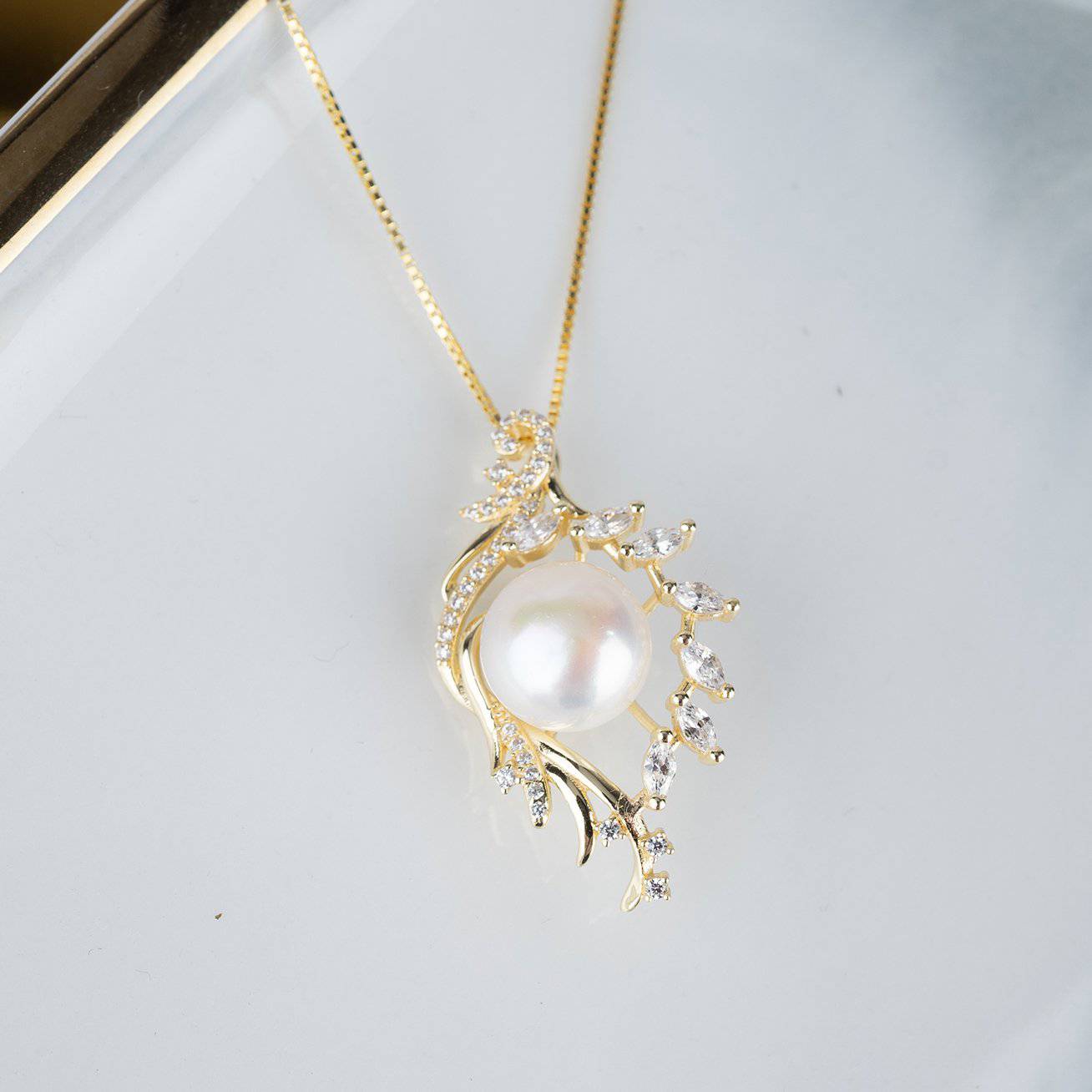 Elegant Freshwater Pearl Necklace WN00092 featuring a white pearl, gold plated sterling silver, and cubic zirconia accents in a leaf design.