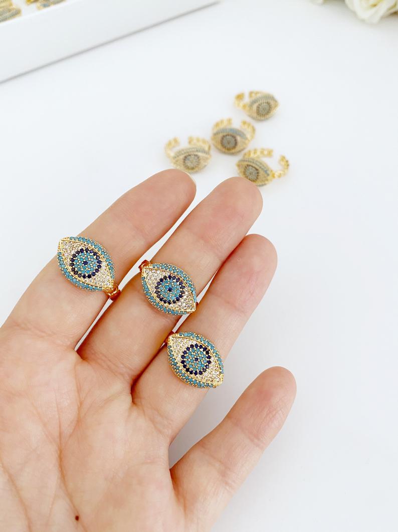 Elegant gold adjustable evil eye ring with zircon charm, symbolizing protection and good luck.