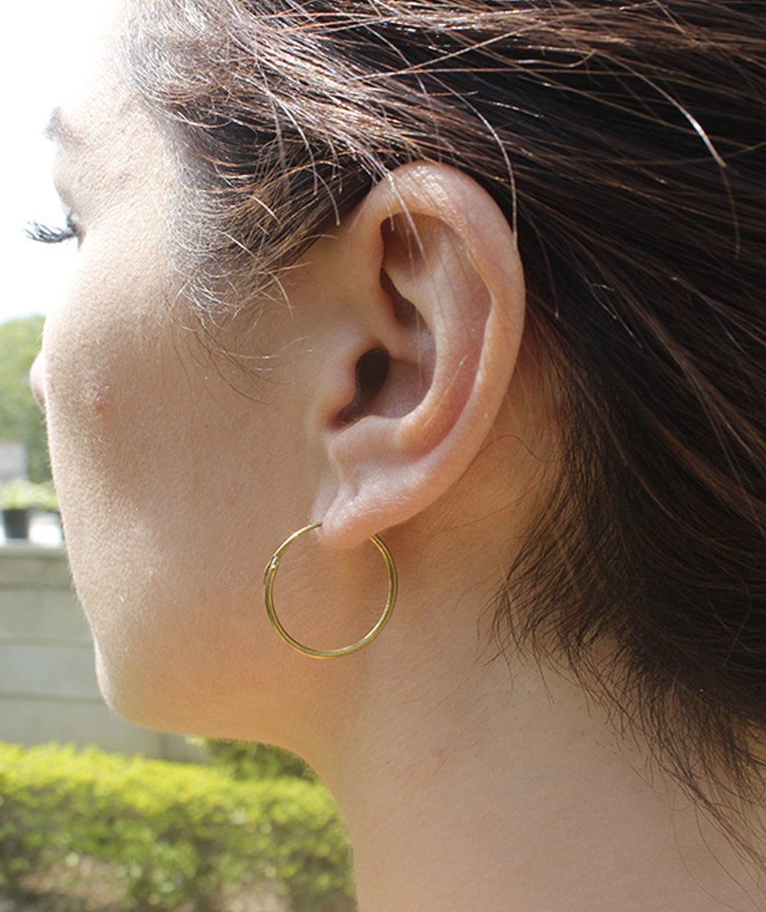 Elegant gold hoop earrings by Urbiana, handmade from brass, lightweight and hypoallergenic, perfect for sensitive skin.