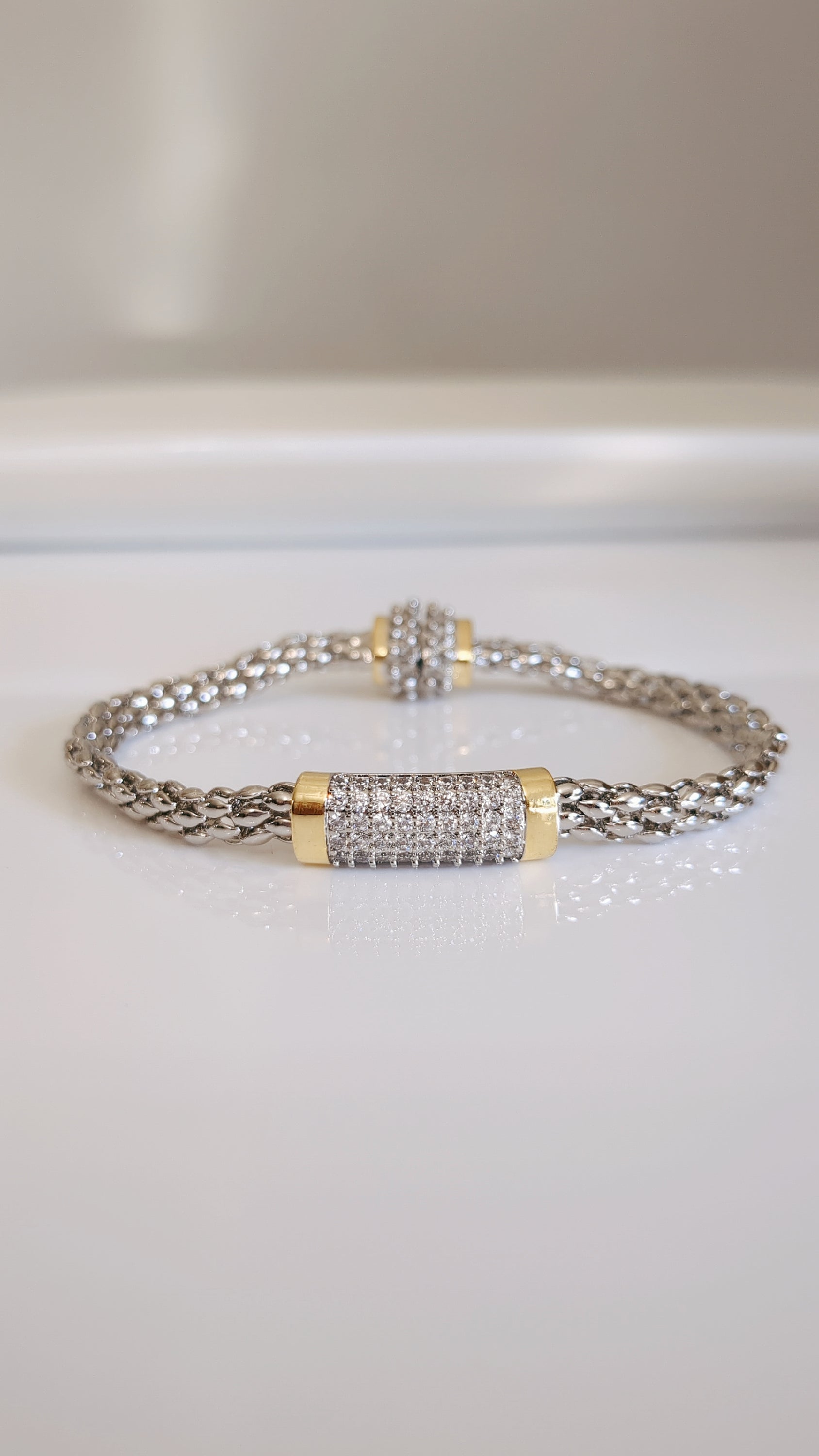 Elegant Magnetic Bracelet featuring a delicate cable pattern and rhodium plating, perfect for stacking or everyday wear.