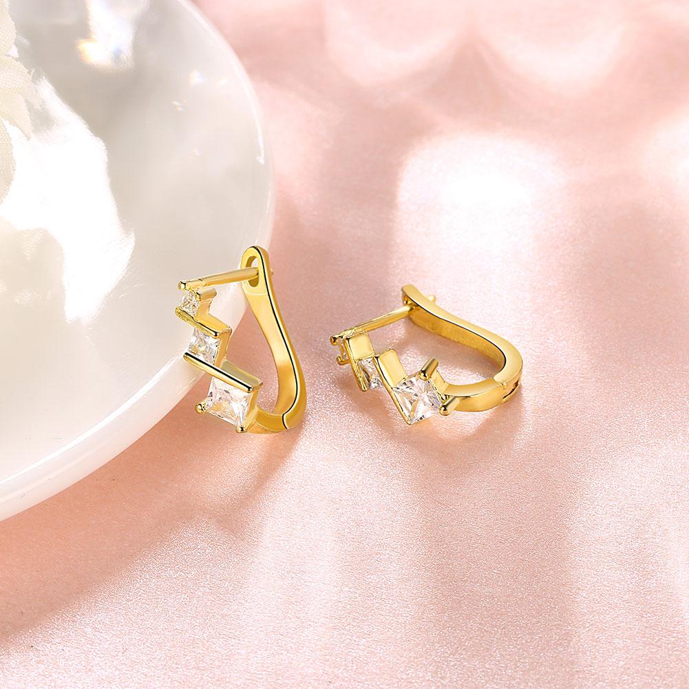 Elements Criss-Cross Clip On Earrings featuring certified crystals and 18K gold plating, elegantly designed for comfort and style.