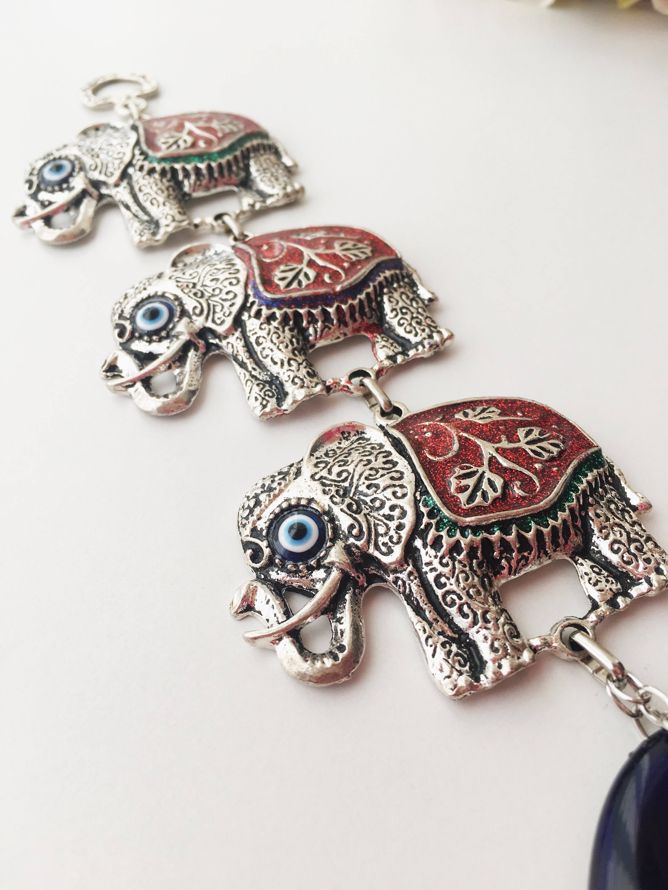 Handmade Elephant Evil Eye Wall Decor featuring a blue evil eye and colorful elephant charm, symbolizing protection and good luck.