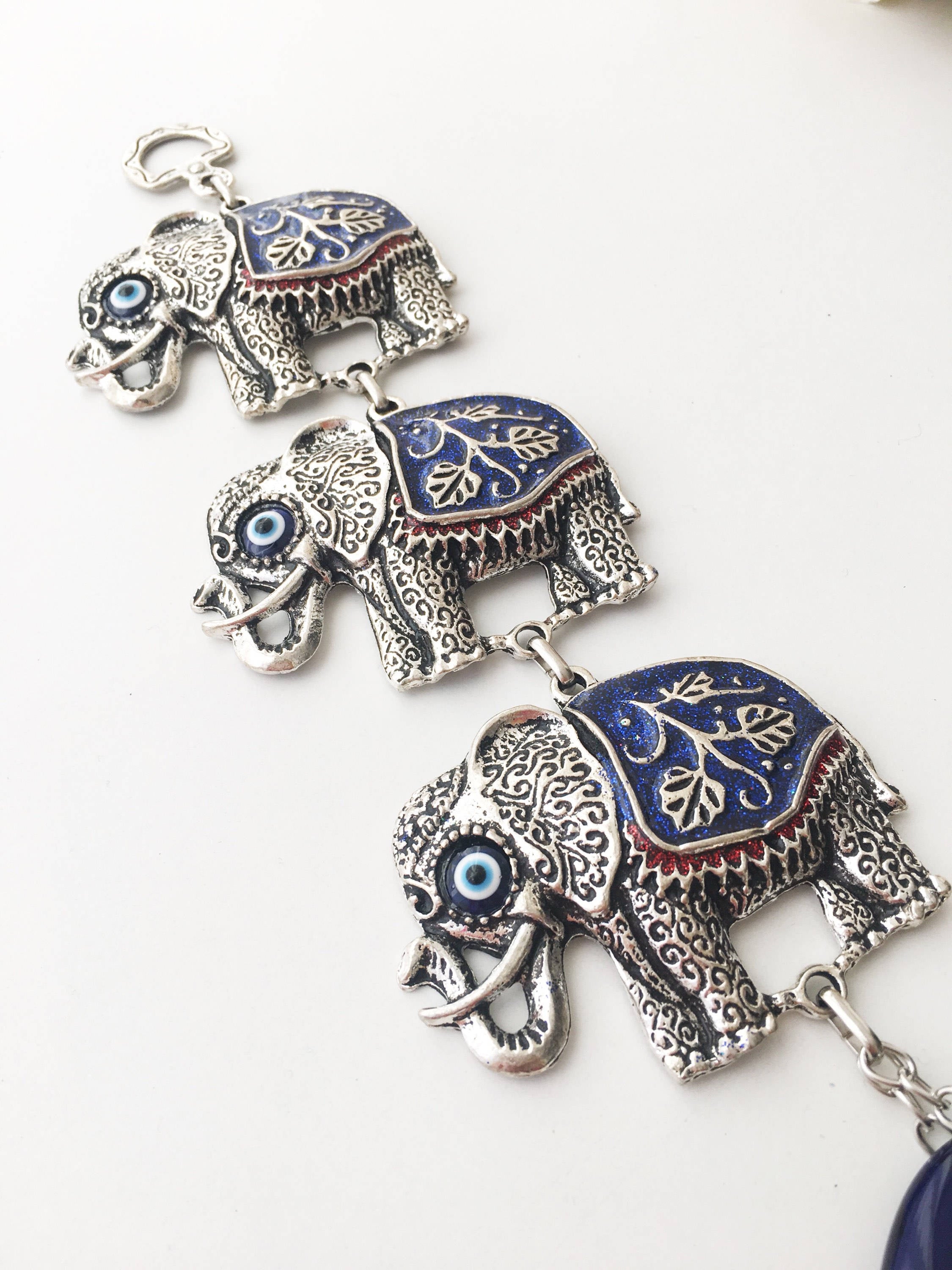 Handmade Elephant Evil Eye Wall Decor featuring a blue evil eye and colorful elephant charm, symbolizing protection and good luck.