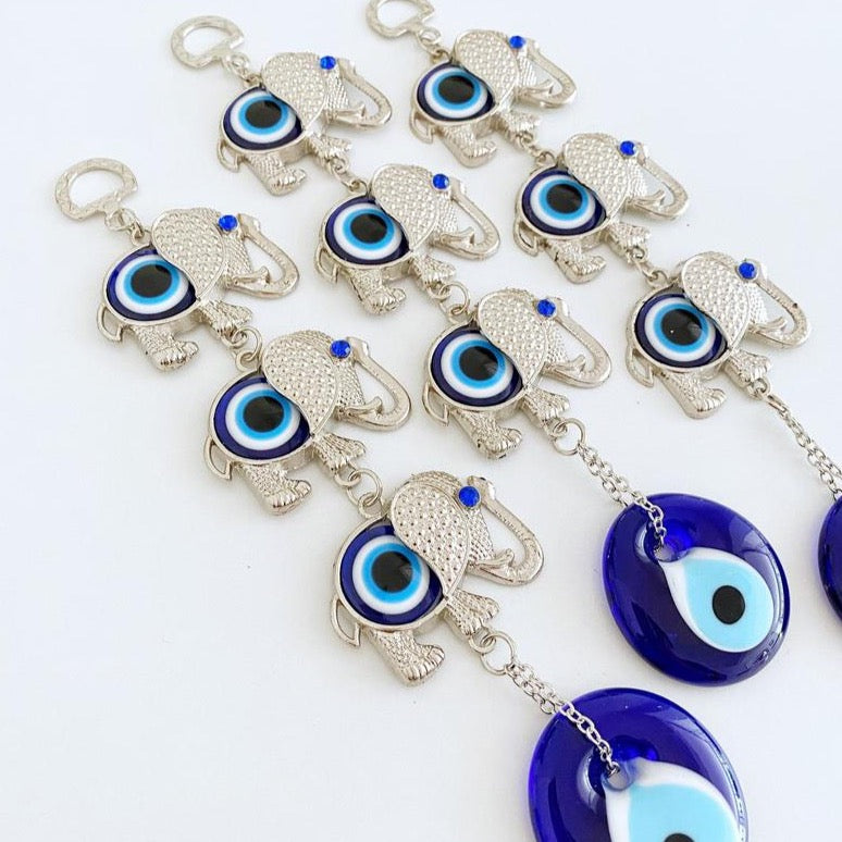 Handmade Elephant Evil Eye Wall Hanging featuring a blue evil eye charm, symbolizing good luck and protection, perfect for home decor.