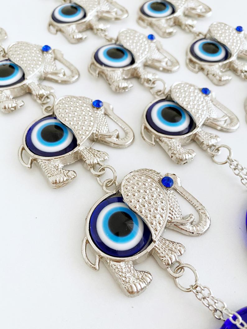 Handmade Elephant Evil Eye Wall Hanging featuring a blue evil eye charm, symbolizing good luck and protection, perfect for home decor.