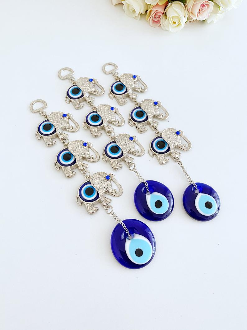 Handmade Elephant Evil Eye Wall Hanging featuring a blue evil eye charm, symbolizing good luck and protection, perfect for home decor.