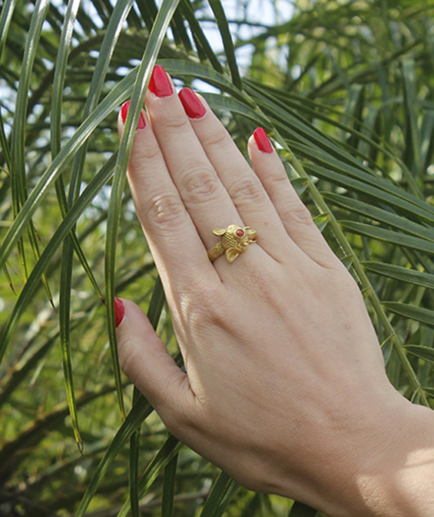 A beautifully crafted elephant ring featuring a semi precious stone, available in gold and silver finishes, showcasing intricate details.