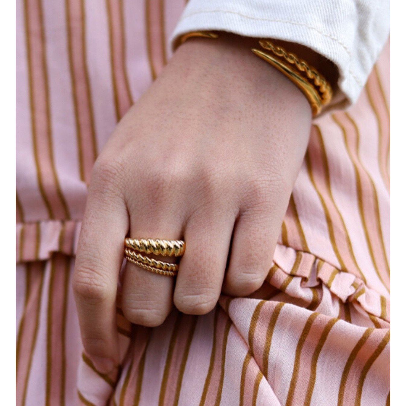 Eli Twist Ring featuring a stylish twist design, 18k gold plated over stainless steel, perfect for any occasion.