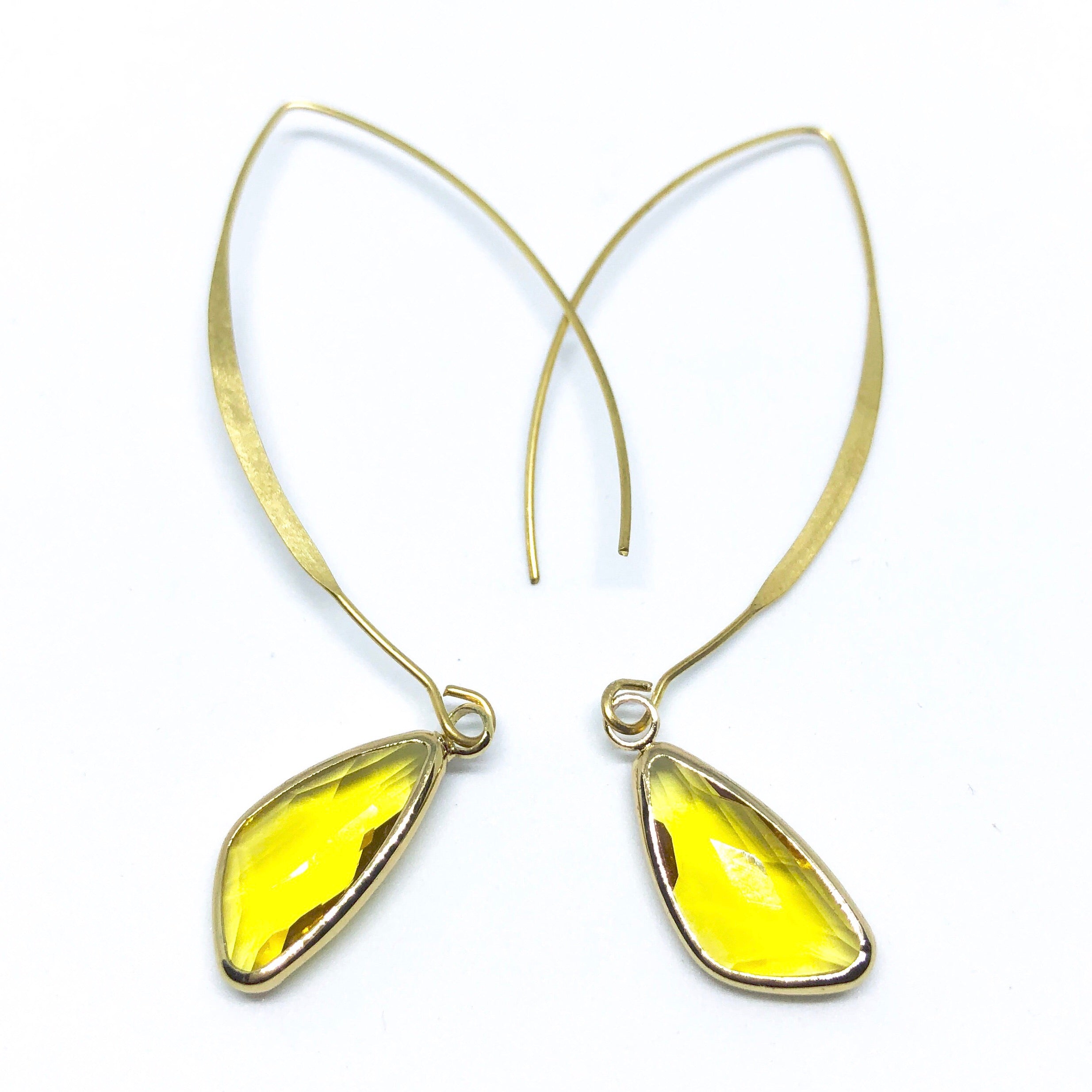 Elise Arc Earrings in gold and silver, showcasing their elegant dangle design and vibrant color options.