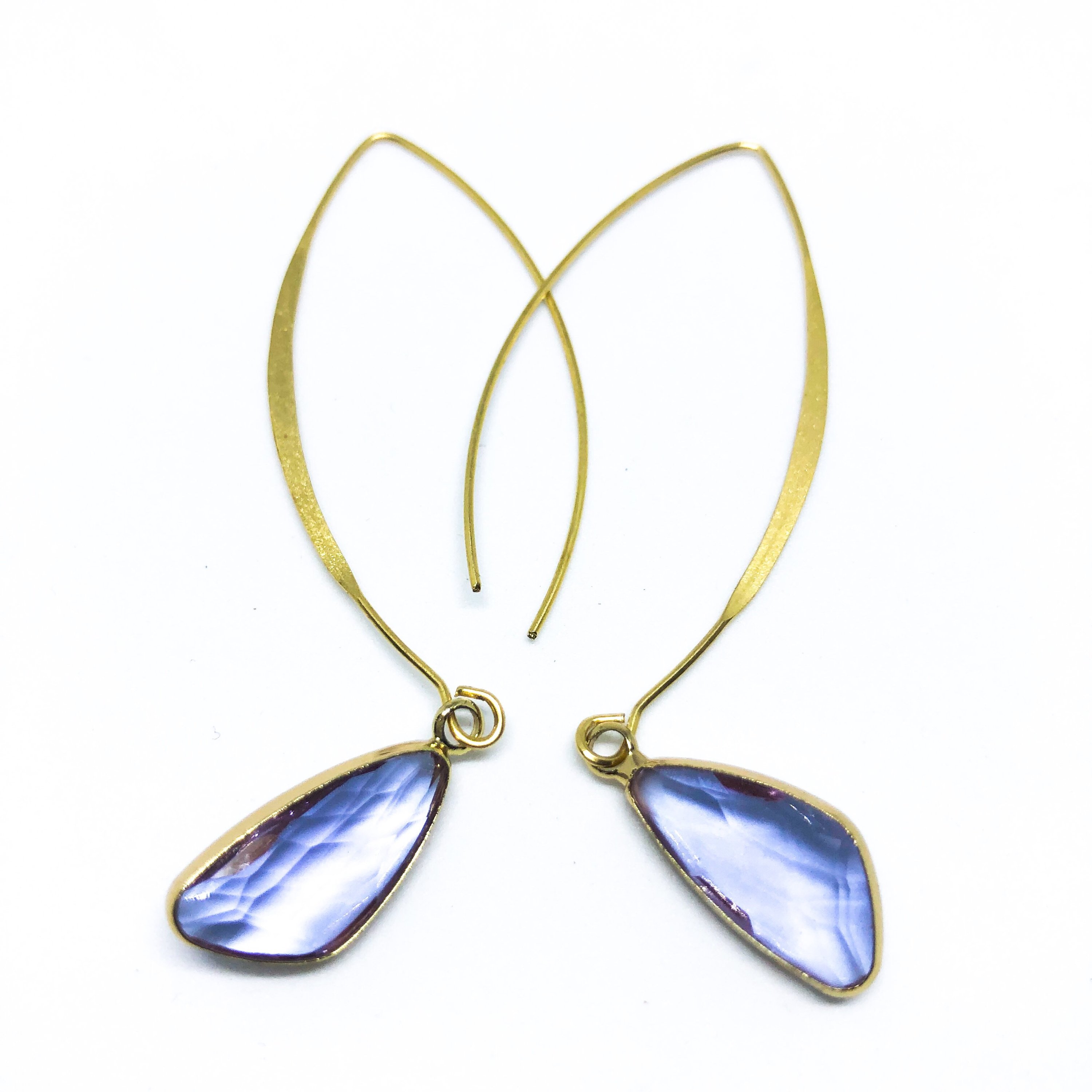 Elise Arc Earrings in gold and silver, showcasing their elegant dangle design and vibrant color options.