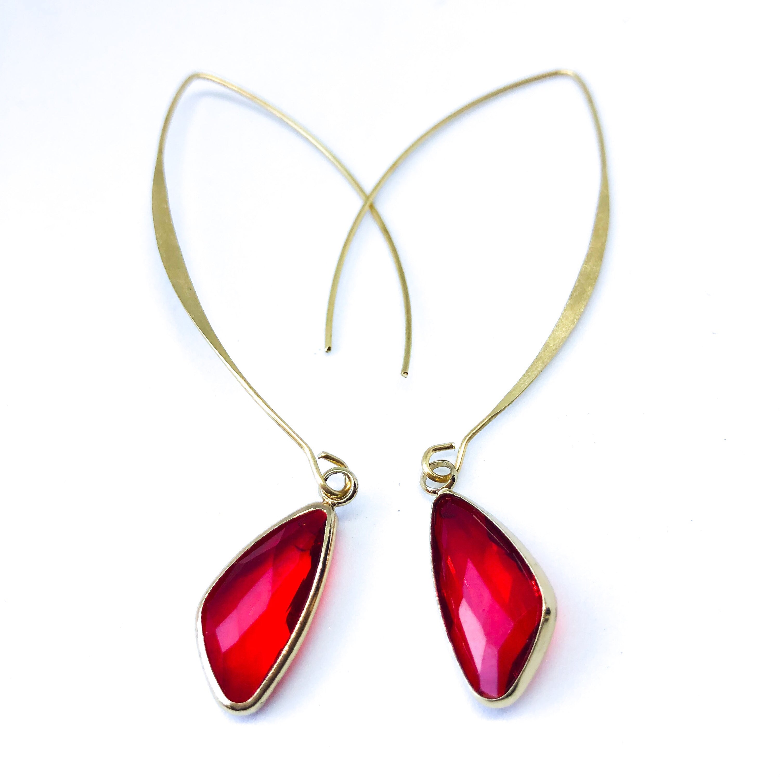 Elise Arc Earrings in gold and silver, showcasing their elegant dangle design and vibrant color options.