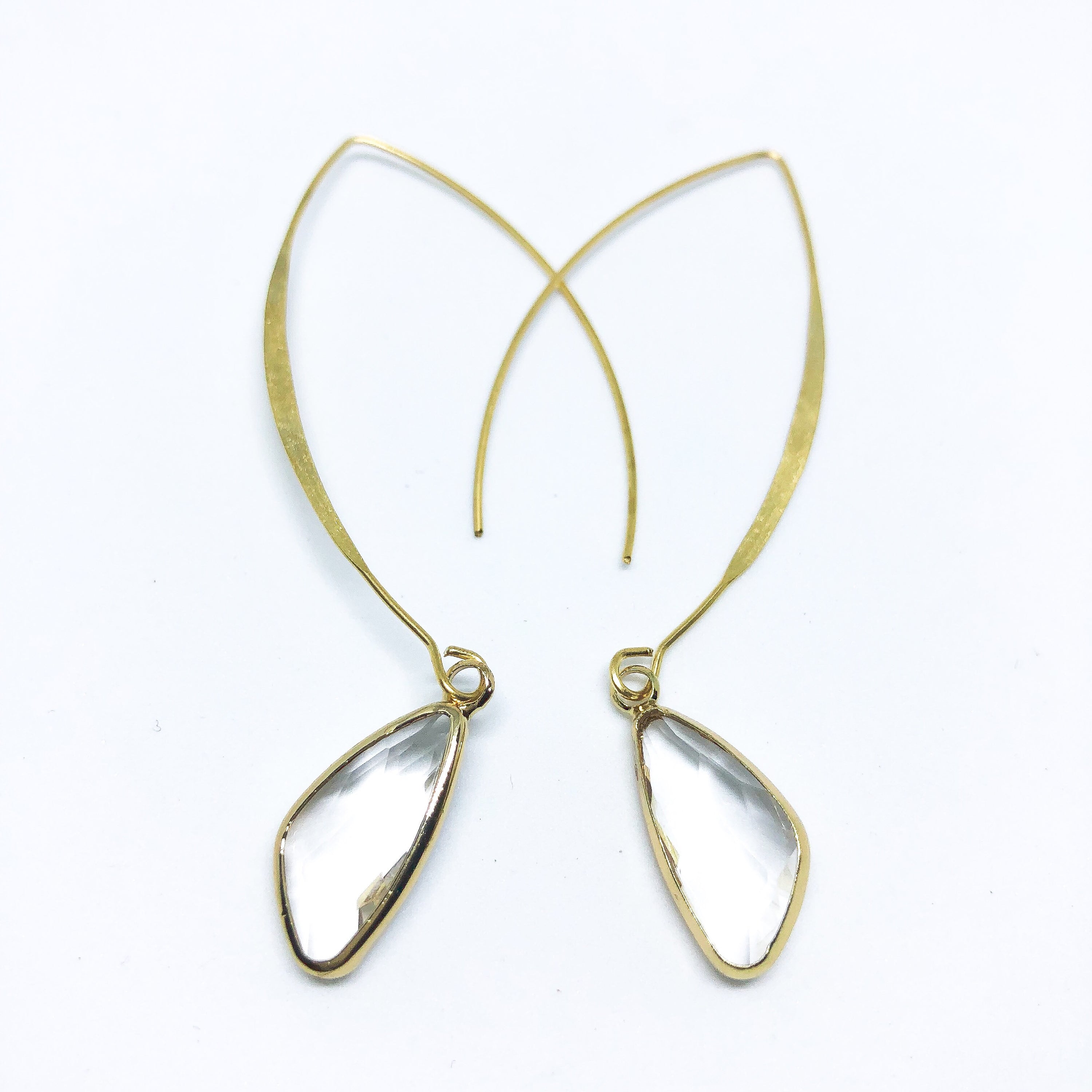 Elise Arc Earrings in gold and silver, showcasing their elegant dangle design and vibrant color options.