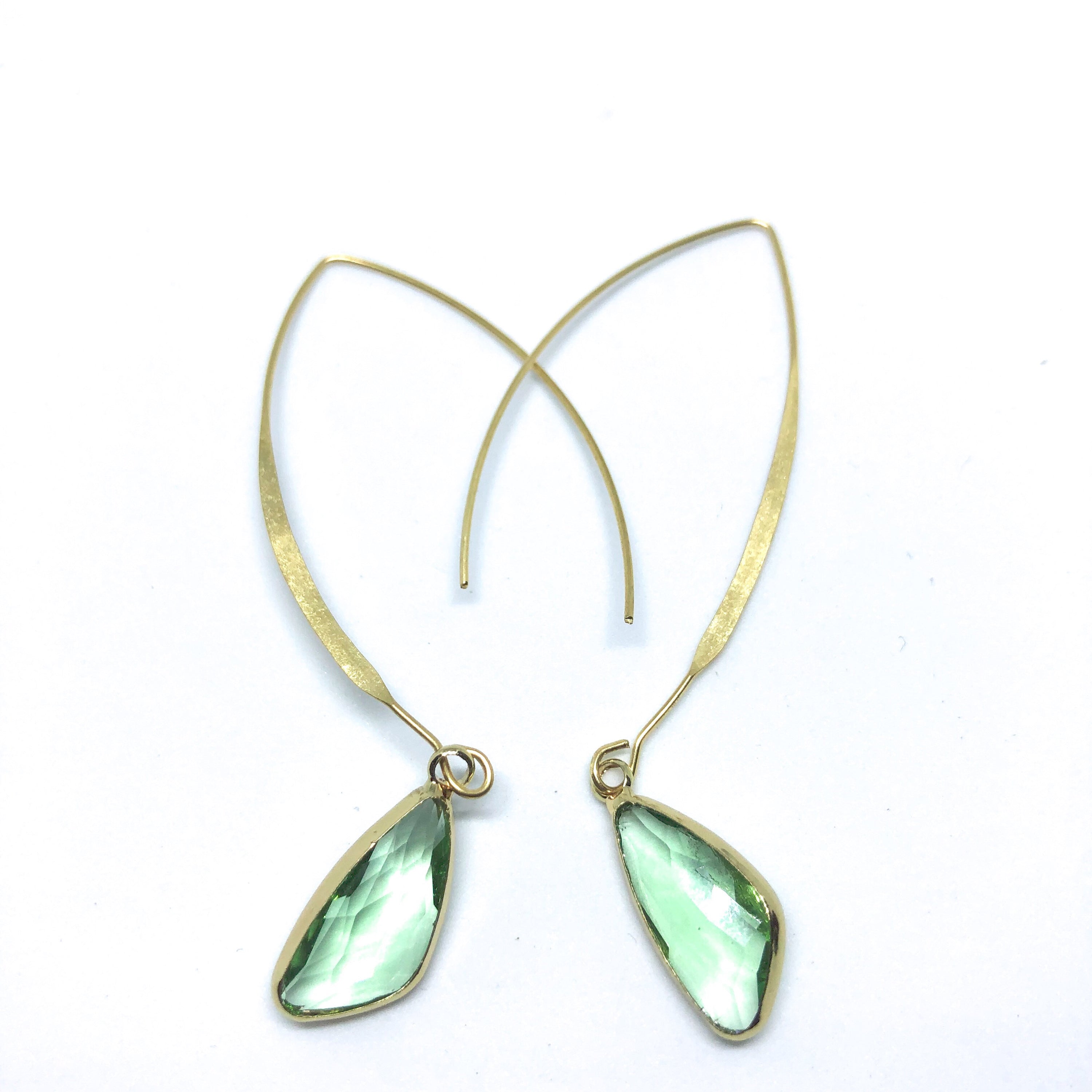 Elise Arc Earrings in gold and silver, showcasing their elegant dangle design and vibrant color options.