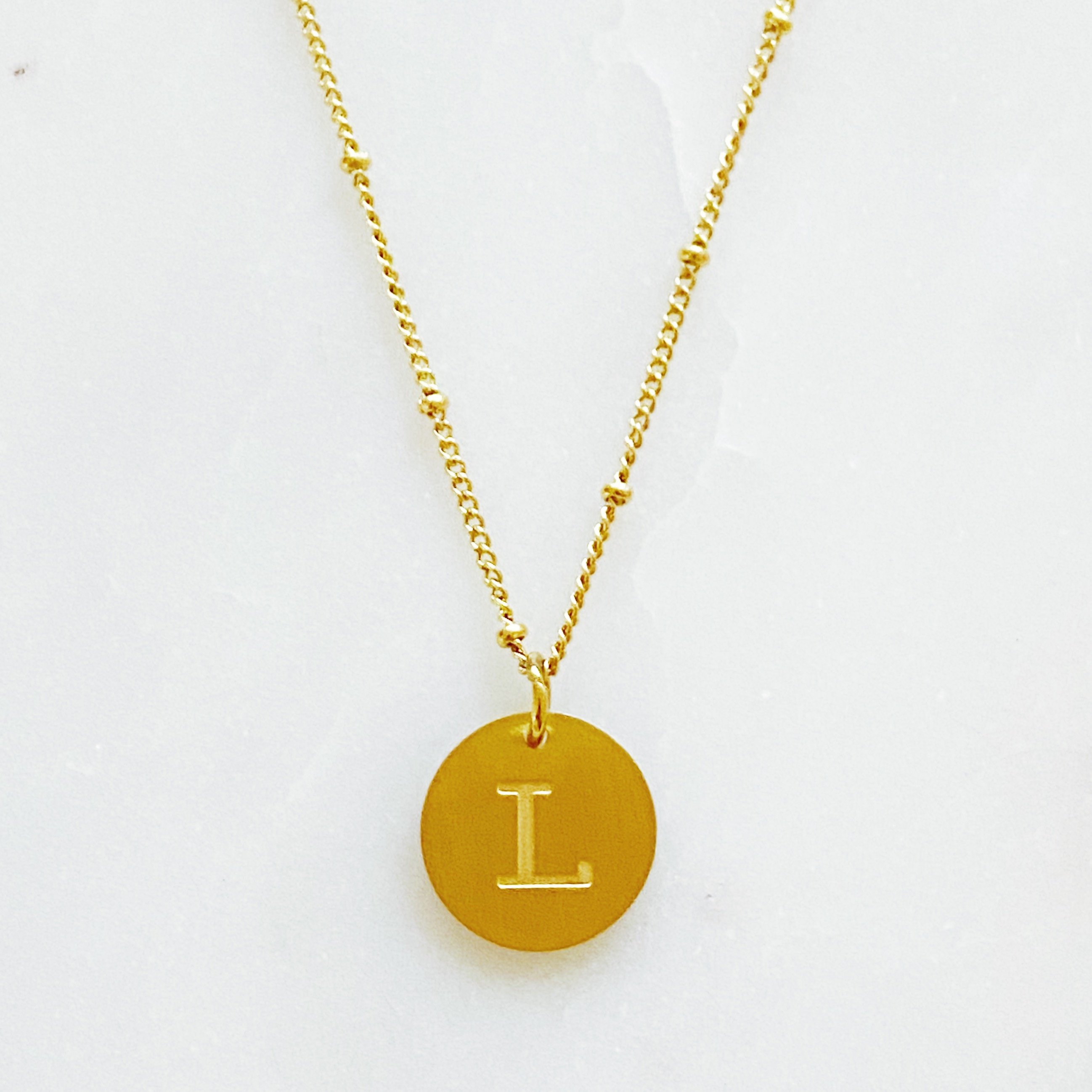 Elegant gold coin initial necklace by Ellison + Young featuring a personalized charm.