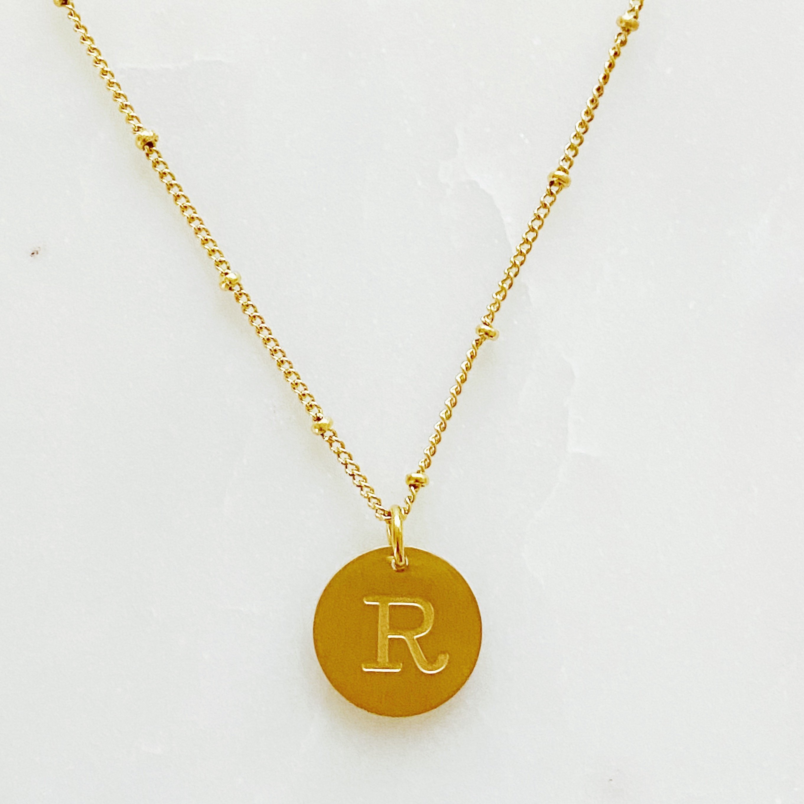 Elegant gold coin initial necklace by Ellison + Young featuring a personalized charm.