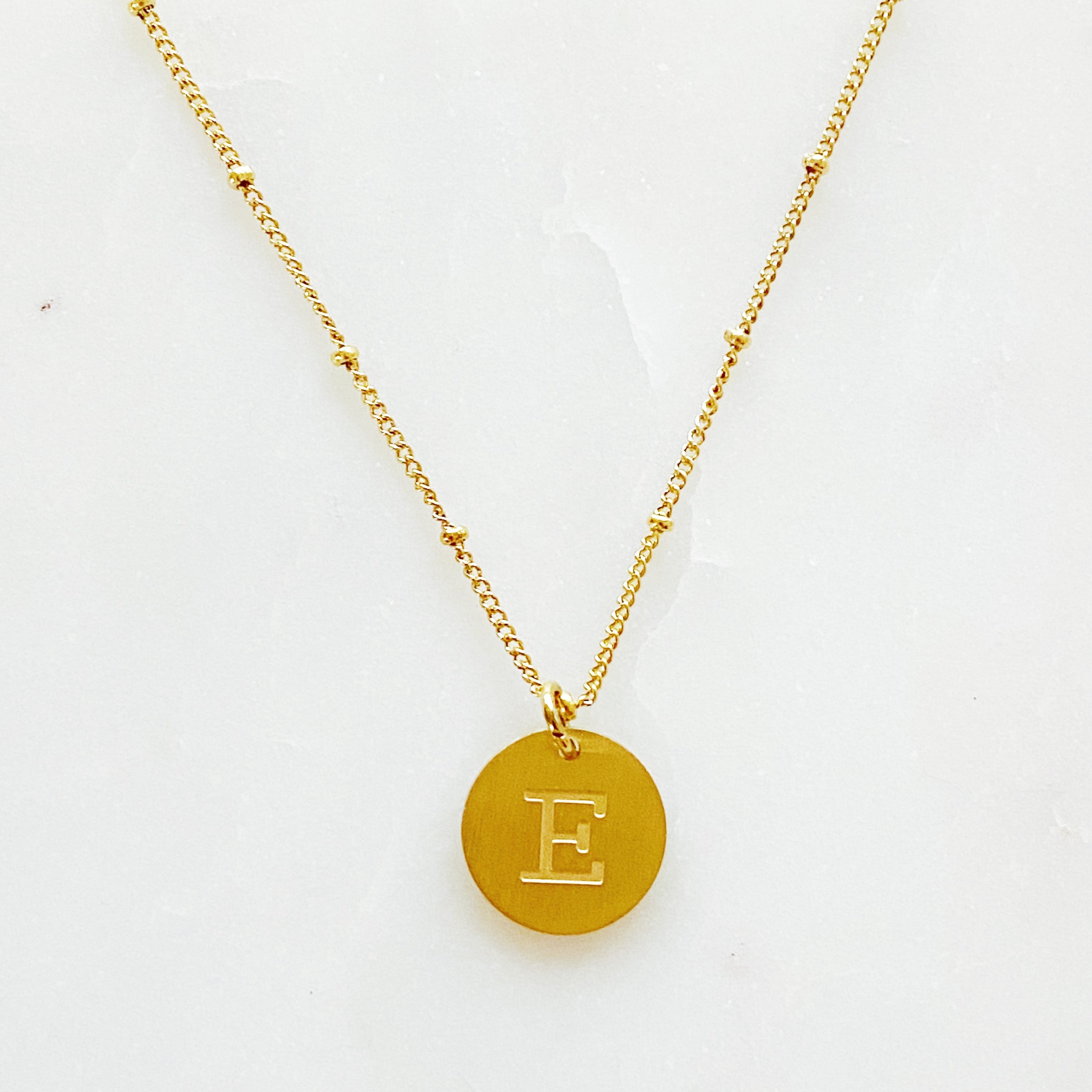 Elegant gold coin initial necklace by Ellison + Young featuring a personalized charm.