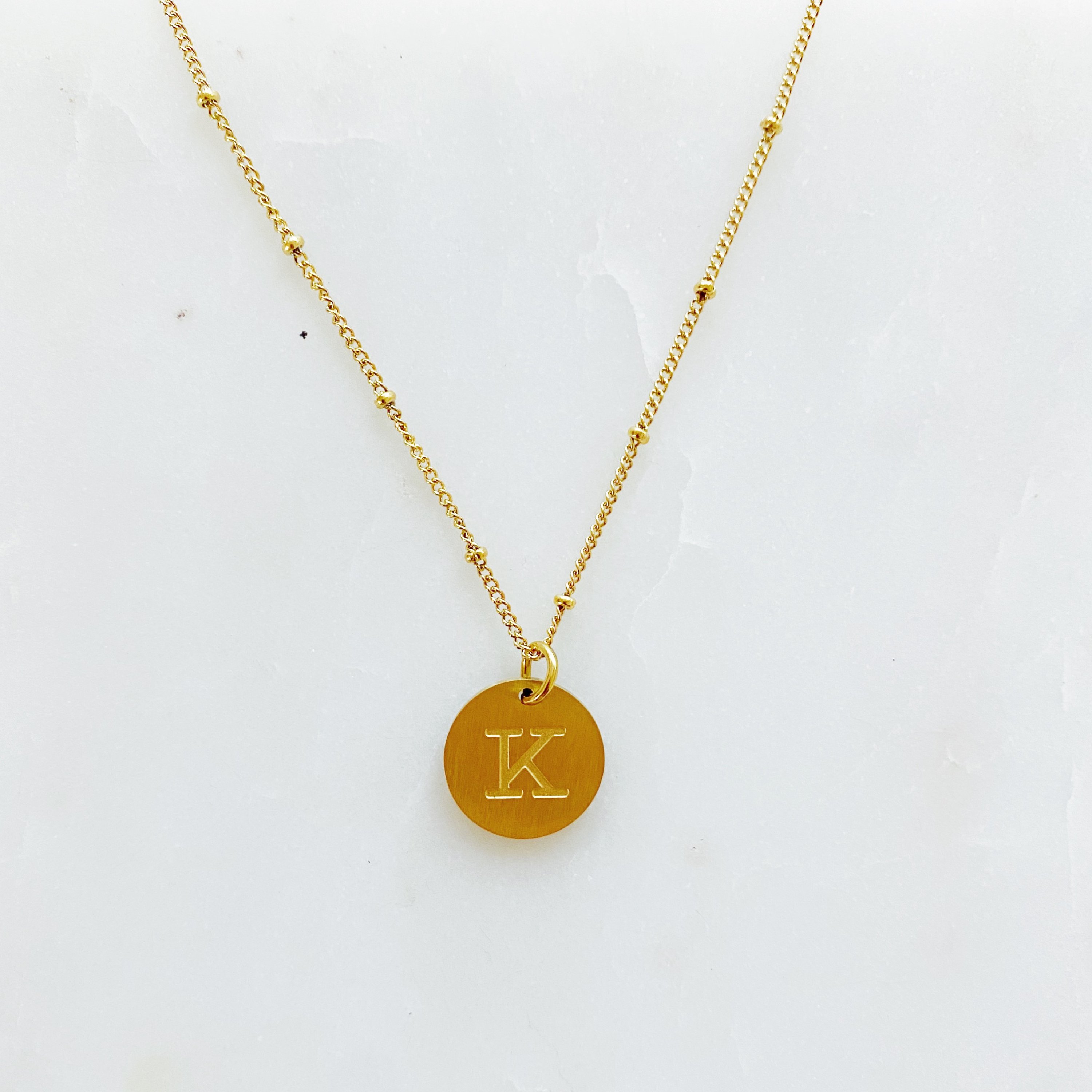 Elegant gold coin initial necklace by Ellison + Young featuring a personalized charm.