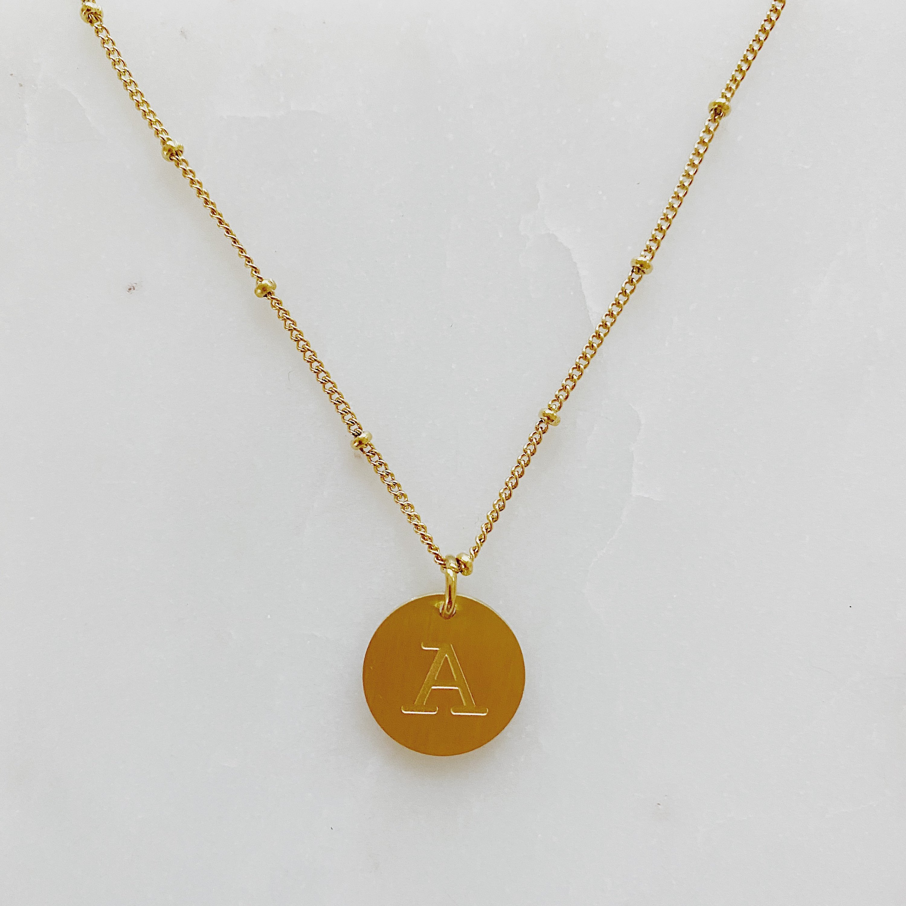 Elegant gold coin initial necklace by Ellison + Young featuring a personalized charm.