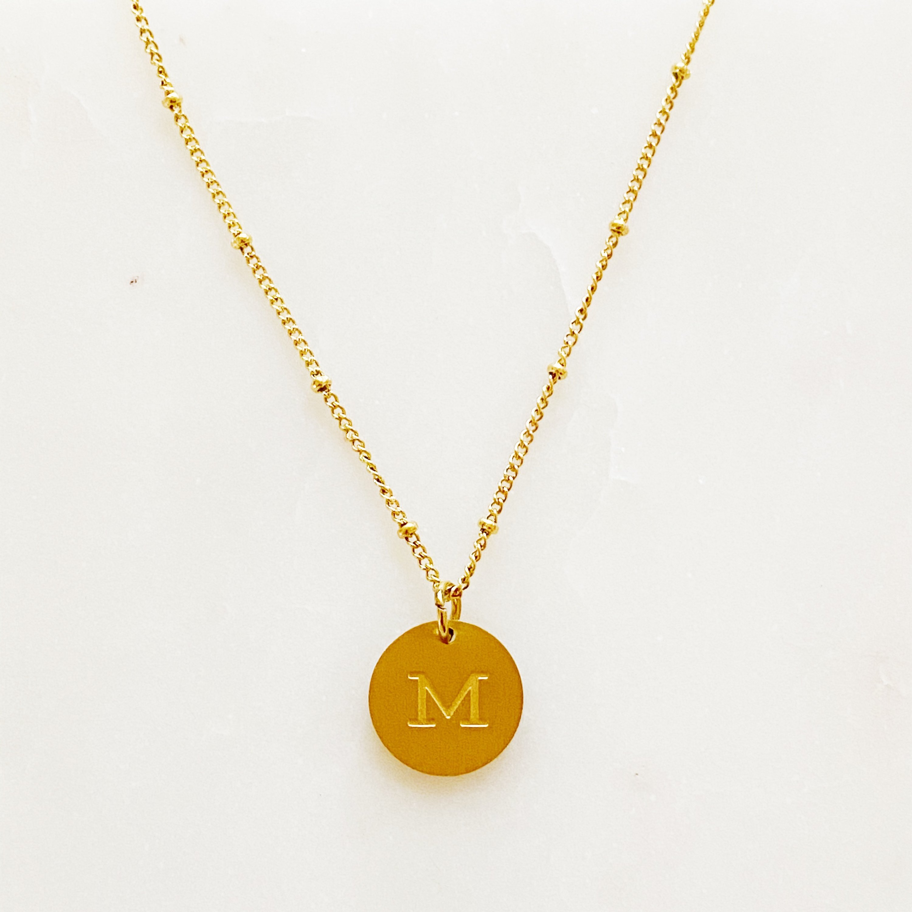 Elegant gold coin initial necklace by Ellison + Young featuring a personalized charm.