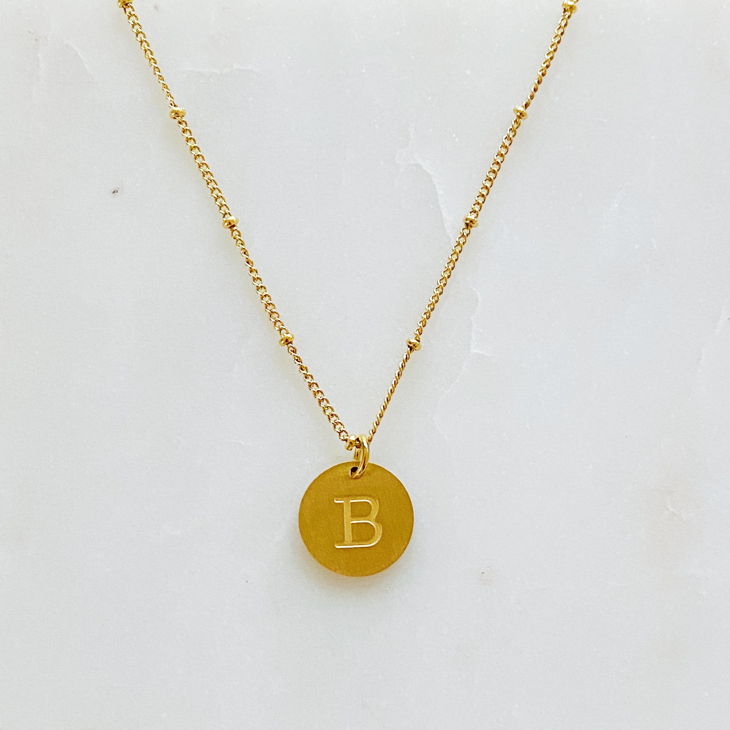 Elegant gold coin initial necklace by Ellison + Young featuring a personalized charm.