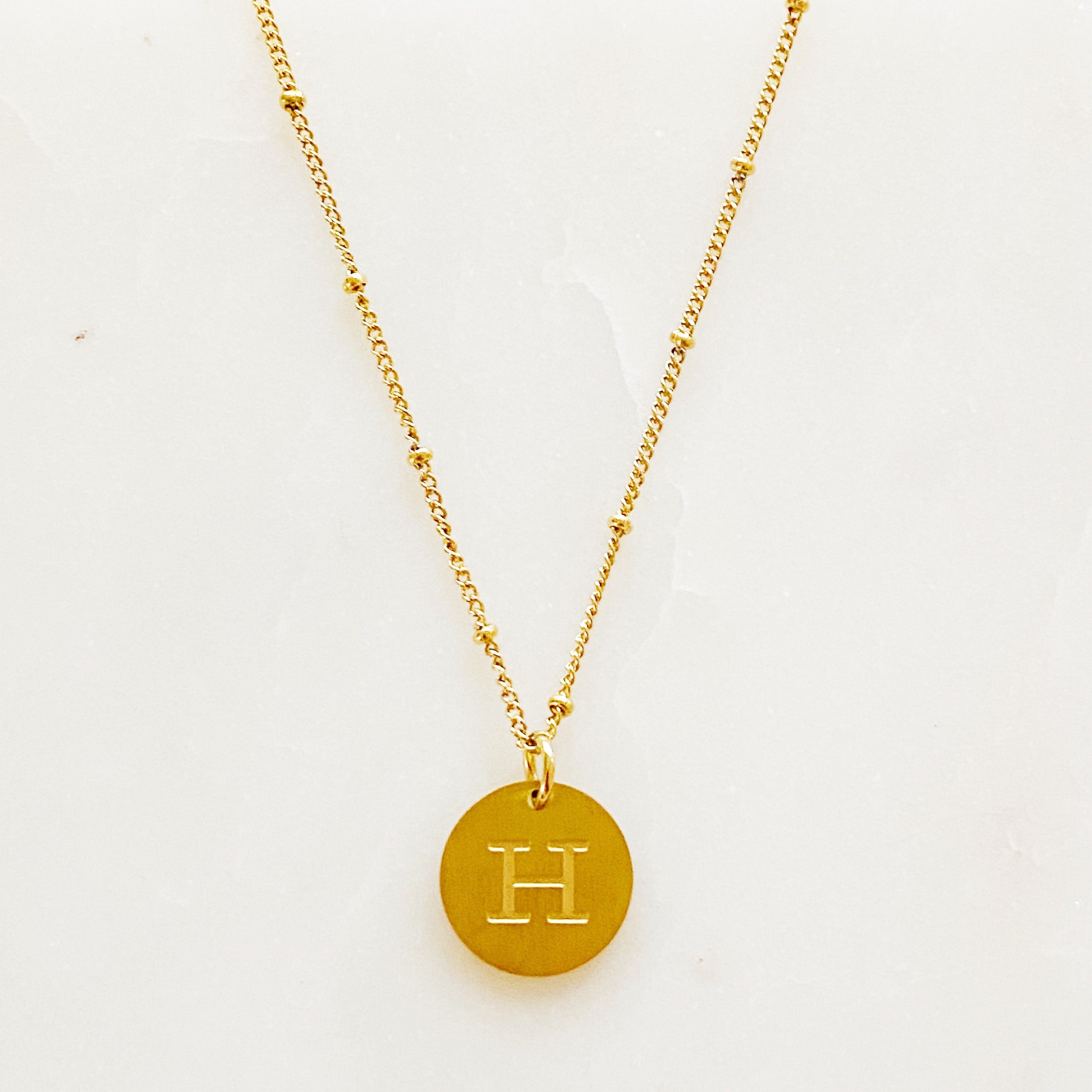 Elegant gold coin initial necklace by Ellison + Young featuring a personalized charm.