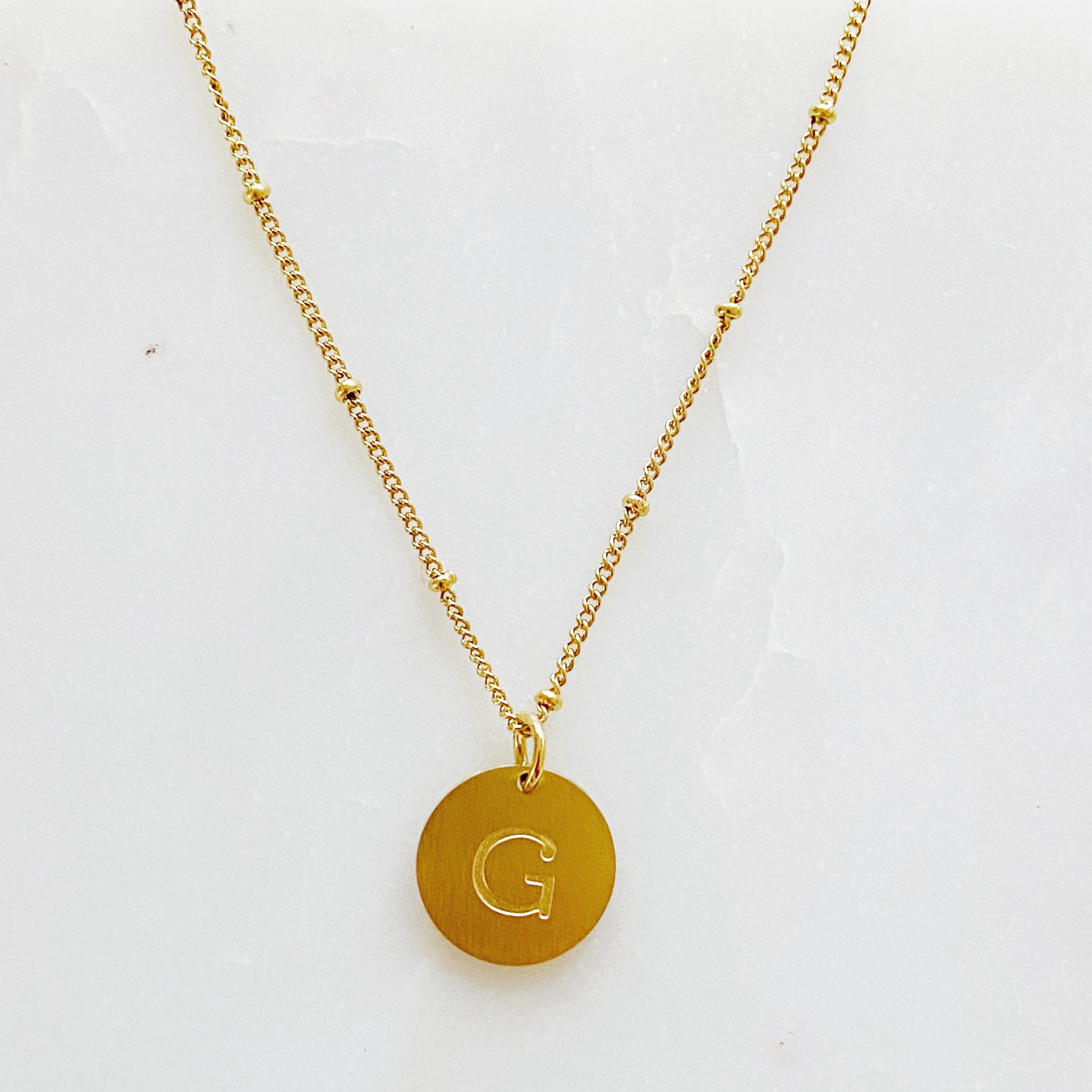 Elegant gold coin initial necklace by Ellison + Young featuring a personalized charm.