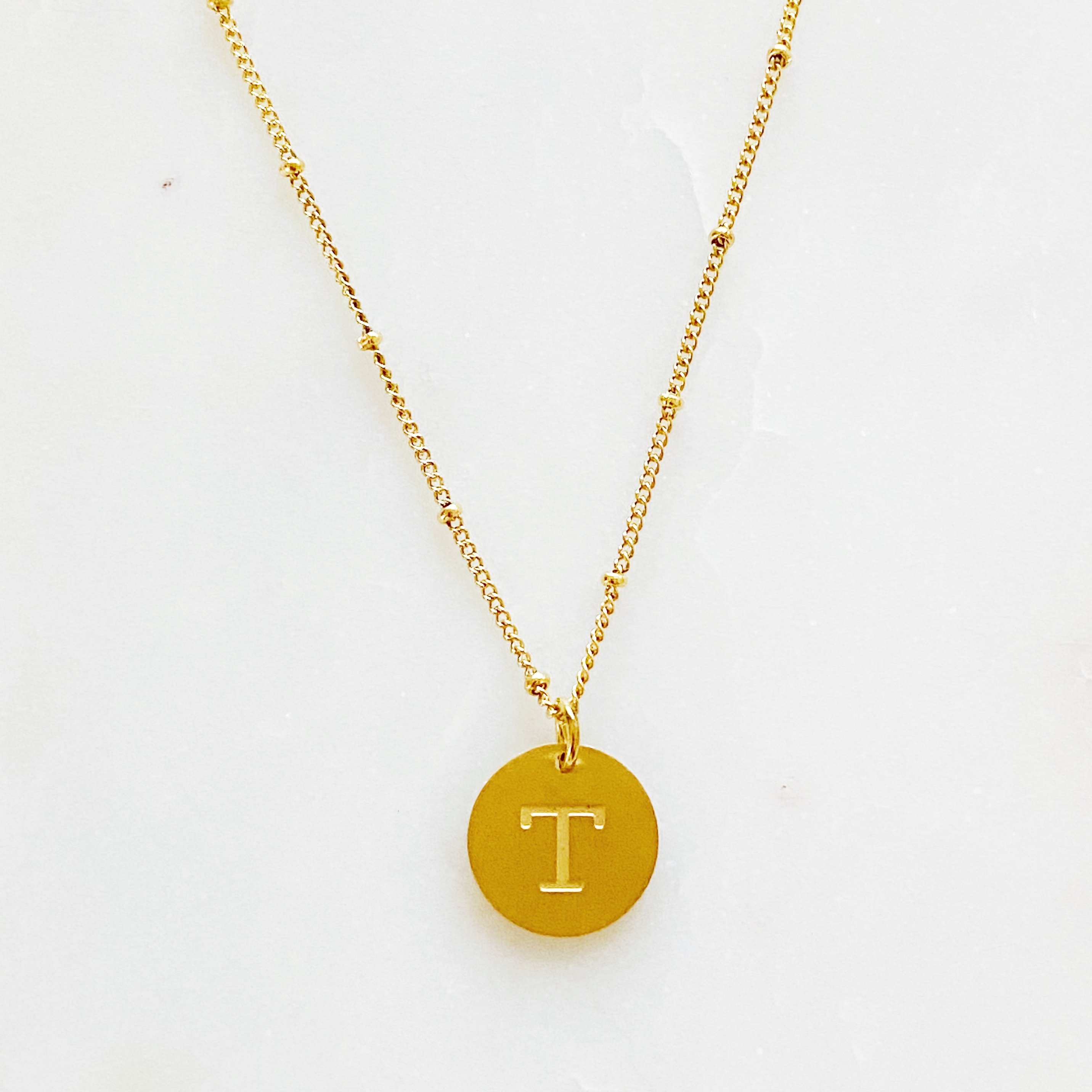 Elegant gold coin initial necklace by Ellison + Young featuring a personalized charm.