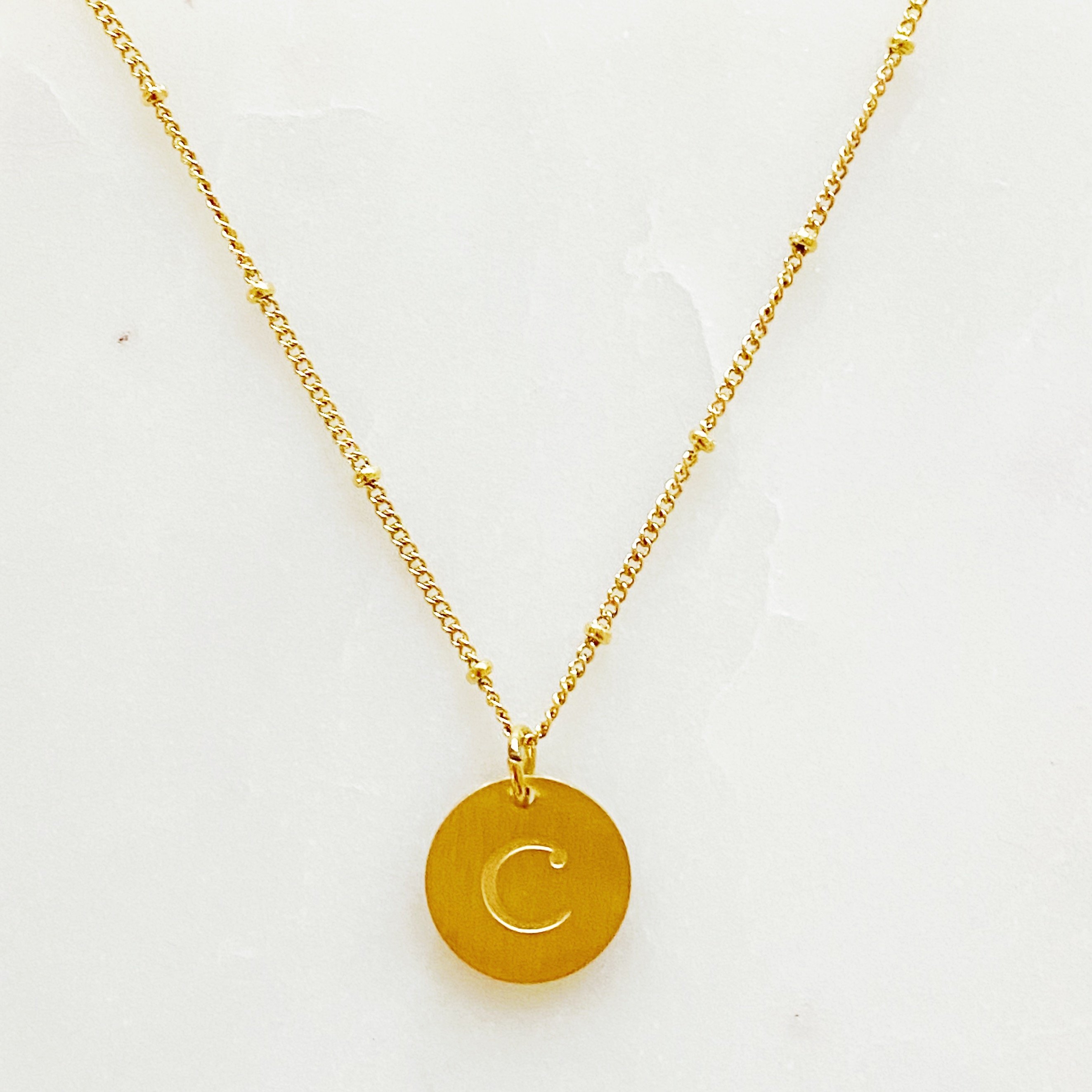 Elegant gold coin initial necklace by Ellison + Young featuring a personalized charm.