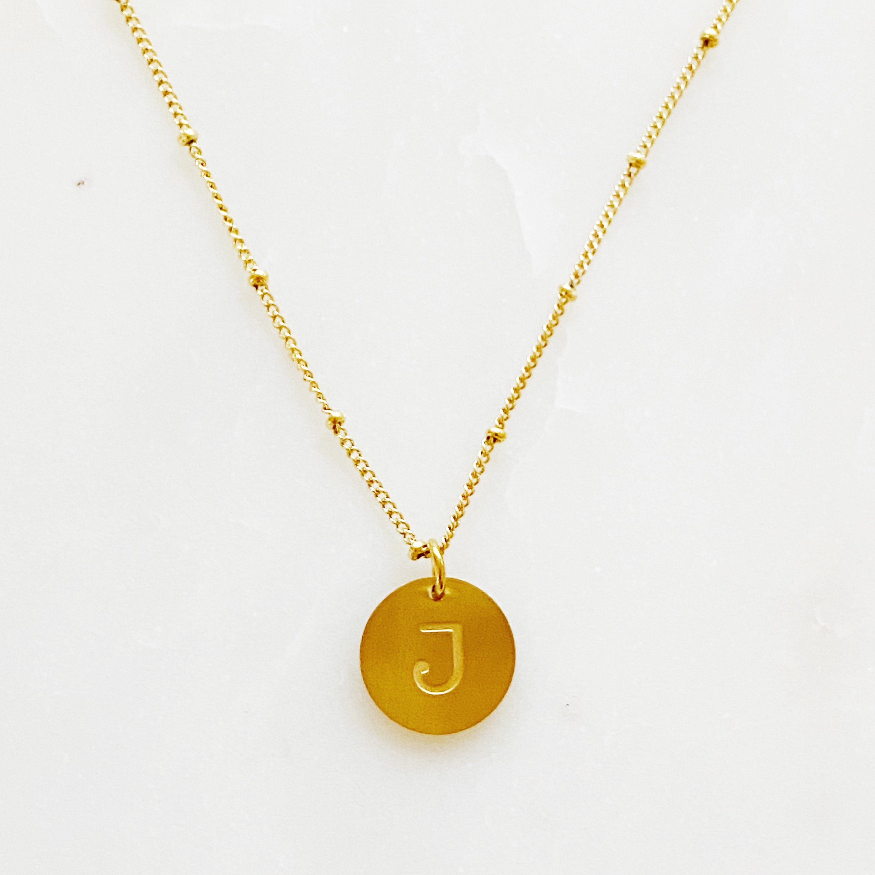 Elegant gold coin initial necklace by Ellison + Young featuring a personalized charm.