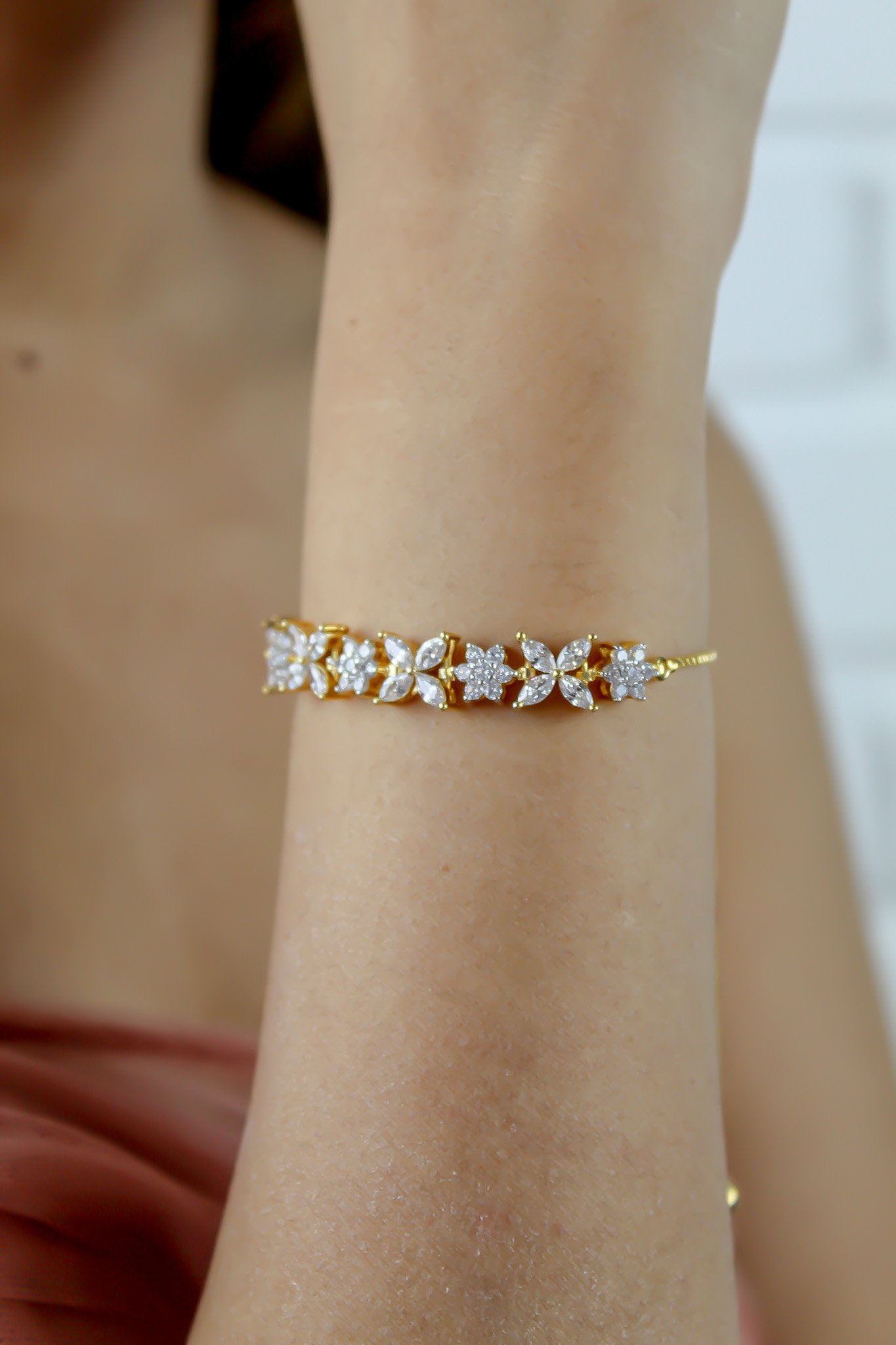 Elegant Elsa Bracelet featuring 18k gold or silver plating with authentic zircons, adjustable design for a perfect fit.