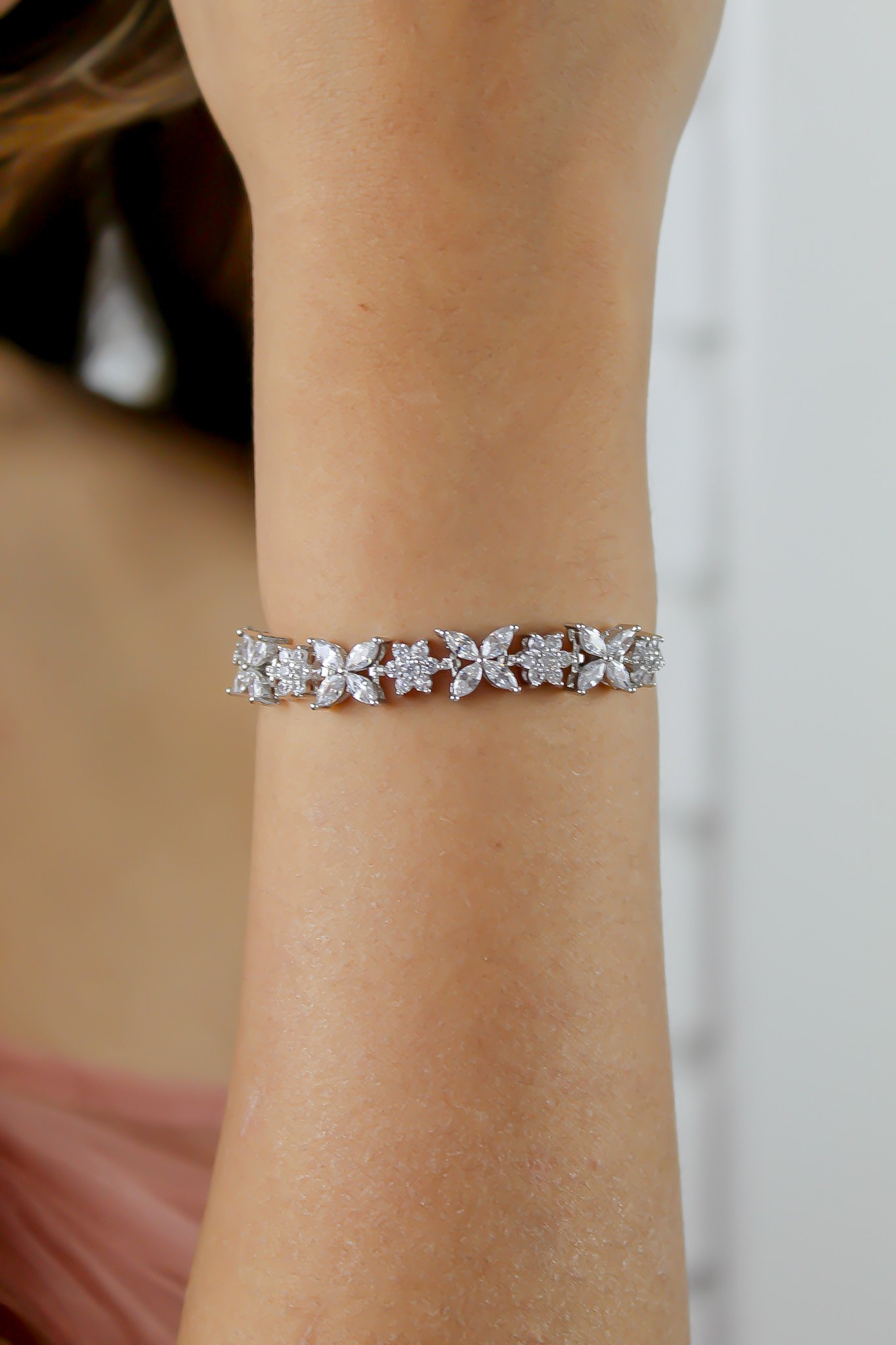 Elegant Elsa Bracelet featuring 18k gold or silver plating with authentic zircons, adjustable design for a perfect fit.